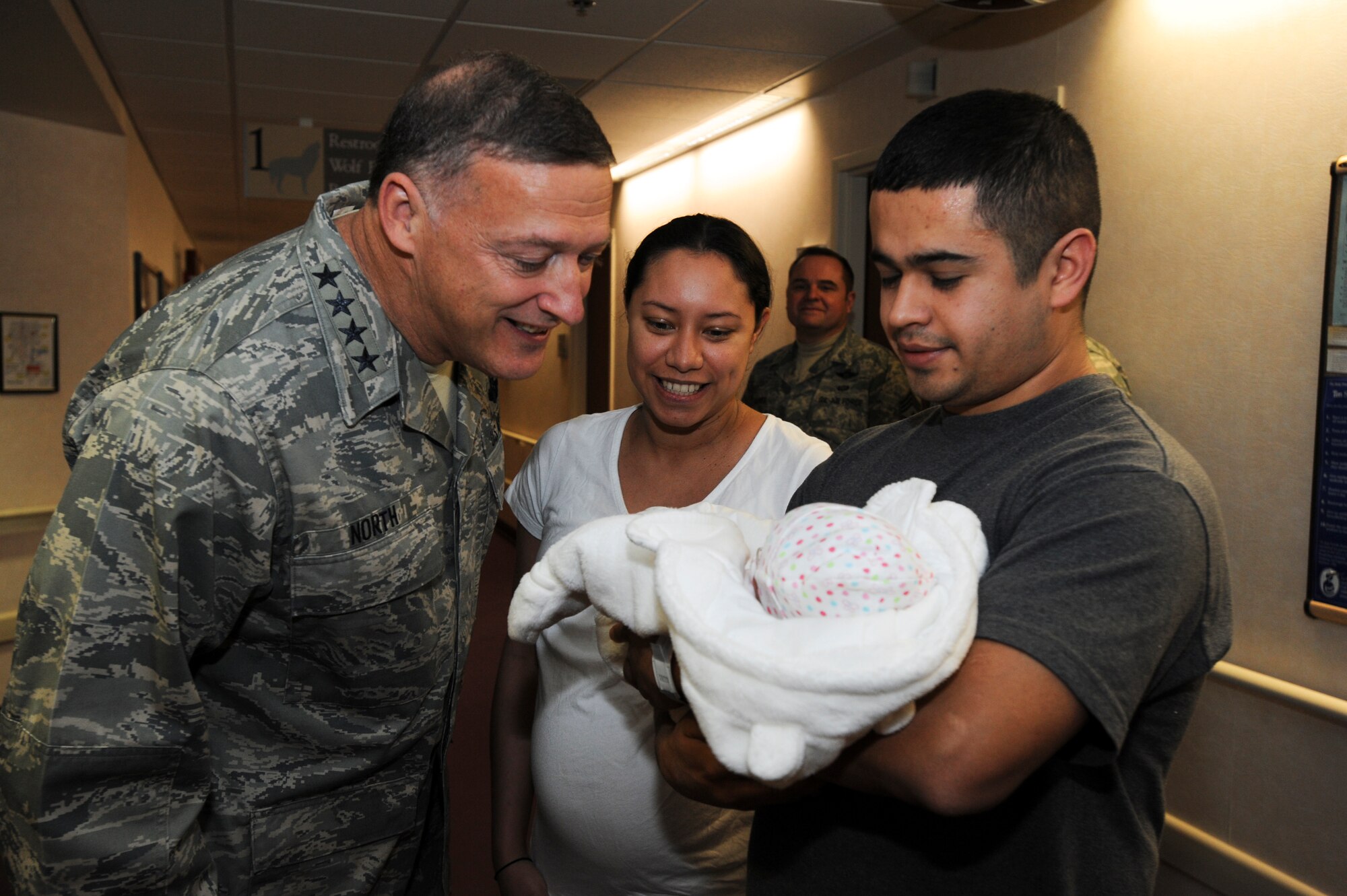 ELMENDORF AIR FORCE BASE -- Pacific Air Forces Commander Gen. Gary North meets Staff Sgt. Vanessa Duarte, 372nd Training Squadron, her husband Miguel Duarte, and their new born baby during his tour of the hospital at Elmendorf Air Force Base, Alaska. General North visited Elmendorf recently as part of his tour of PACAF bases. (U.S. Air Force photo/ Staff Sgt. Joshua Garcia)