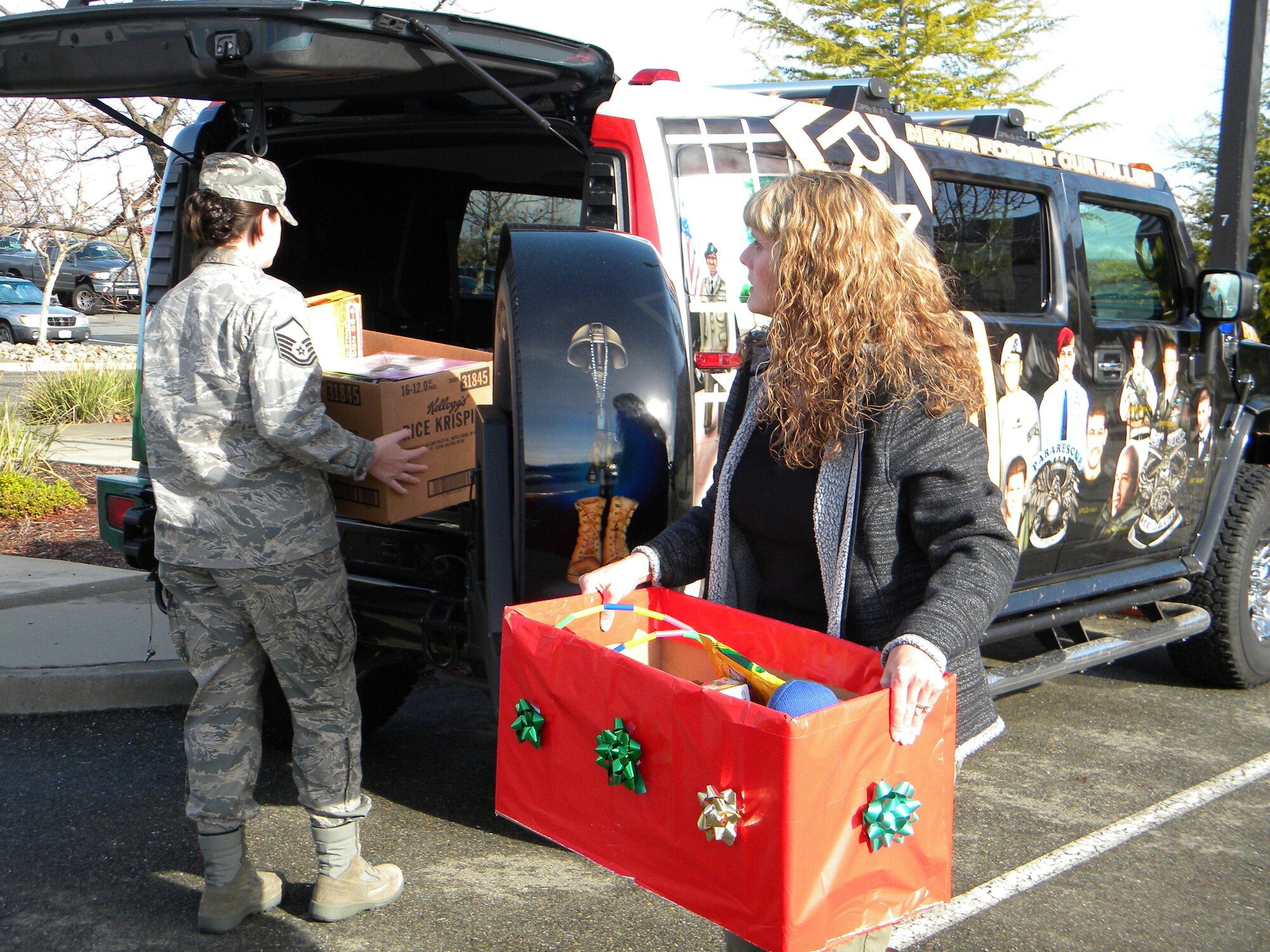 Members of the 940th Wing, Beale AFB, Calif., load donated toys into a custom-painted Humvee.  The vehicle, dedicated to the rememberance of Army Ranger Kristofer Thomas and the men who died with him in Afghanistan in 2007, will take the toys to a Military Children's Christmas Party, Dec. 19, in Roseville, Calif.  The third annual party is being sponsored by Never Forget Our Fallen, a non-profit organization founded by Ranger Thomas's mother, Deborah Getz.  