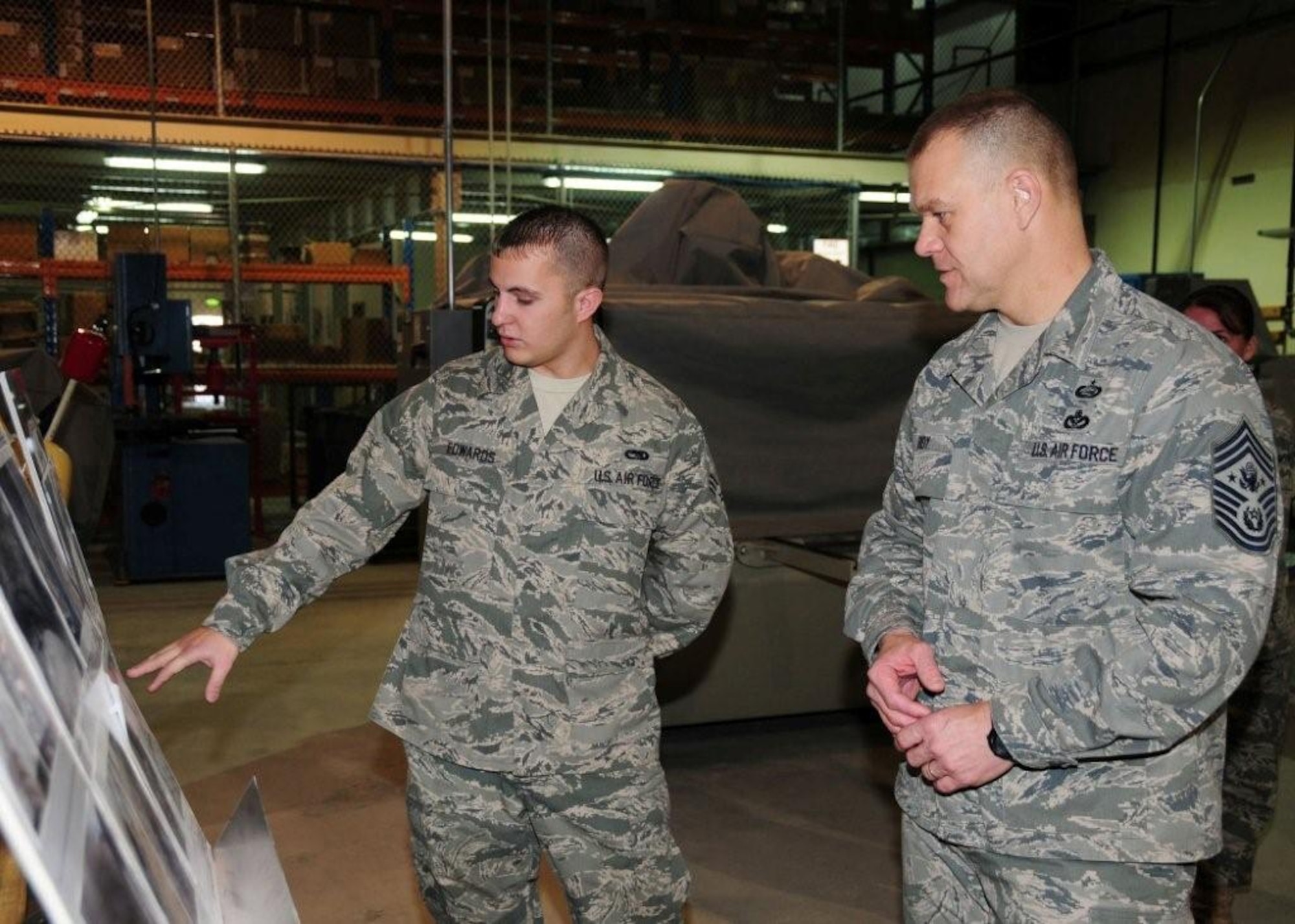 Chief Master Sgt. of the Air Force James A. Roy, is briefed by Senior Airman Steven Edwards, 386th Expeditionary Maintenance Squadron metals technician journeyman, on the combat metals shop during a visit to the 386th Air Expeditionary Wing at an undisclosed location in Southwest Asia recently. Airman Edwards is deployed from the 509th Maintenance Squadron, Whiteman Air Force Base, Mo., and hails from Charleston, S.C. (U.S. Air Force photo/Tech. Sgt. Tony Tolley)
