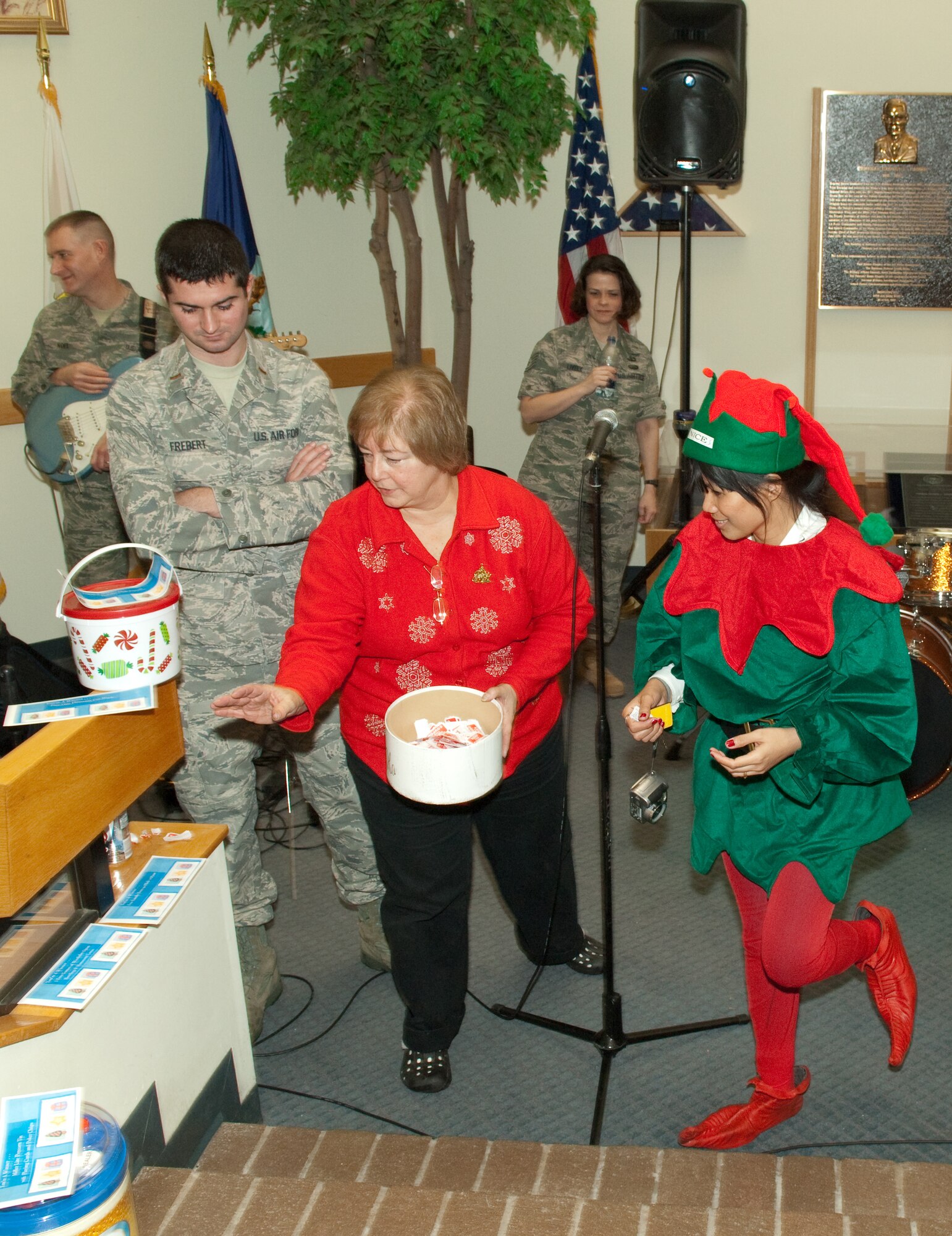 HANSCOM AIR FORCE BASE, Mass. -- Twinkle Murray, Hanscom Inn guest services representative, wins a raffle prize for free bowling during the 66th Air Base Wing Holiday Party Dec. 10 as 2nd Lt. Matt Frebert, 66 ABW project action officer, and Denise Beaudry, commander’s action office chief, distribute the prizes. Organizations from around Hanscom, including the Hanscom Credit Union, the Commissary and the Base Exchange, donated gift certificates and other prizes to a handful of winners for the event. (U.S. Air Force Photo by Rick Berry)