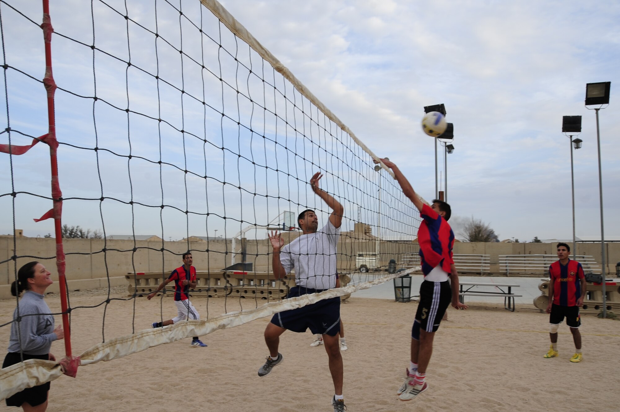 Ali Base, Iraq - Airmen and Soldiers assigned to the Tallil Logistics Military Advisory Team host Iraqi soldiers for a friendly game of volleyball here Dec. 16, 2009.  The LMAT is one of nine teams assisting the Iraqi Army in their efforts to assume independent operations.  The LMAT hosted the event to continue to build trust and rapport with their Iraqi counterparts. (U.S. Air Force photo/Master Sgt. Darrell Habisch)  