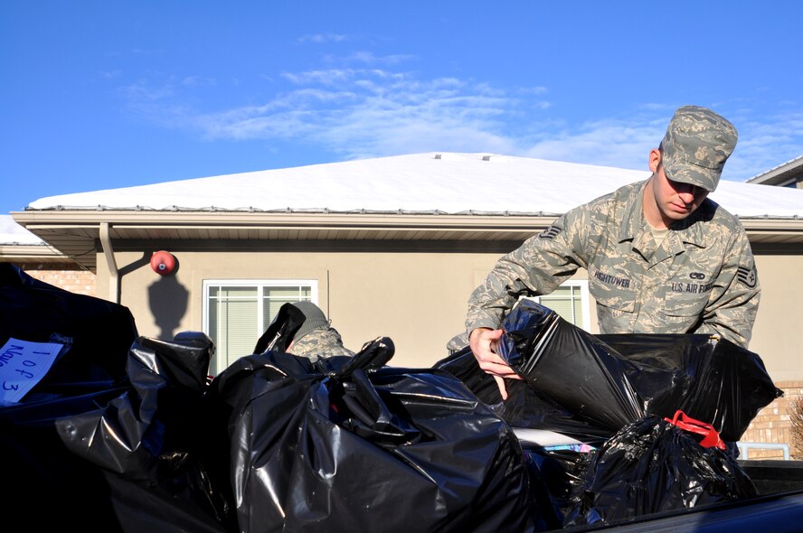 Staff Sgt. Allen Hightower, of the 419th Maintenance Squadron, loads one last bag of gifts before heading out to hand-deliver them to local children in foster care Dec. 15. (U.S. Air Force photo/Bryan Magaña)