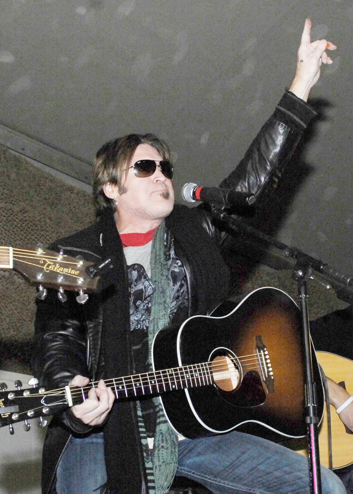 Billy Ray Cyrus entertains the Airmen, Soldiers, Sailors and Marines at Bagram Airfield during a United Service Organization tour Dec. 15, 2009.  Mr. Cyrus, Dave Attell, Anna Kournikova, and Nick Bollettieri attended the USO tour to boost the morale of the servicemen and women. Mr. Cyrus is a singer/actor and hails from Flatwoods, Ky. (U.S. Air Force photo/Senior Airman Felicia Juenke)