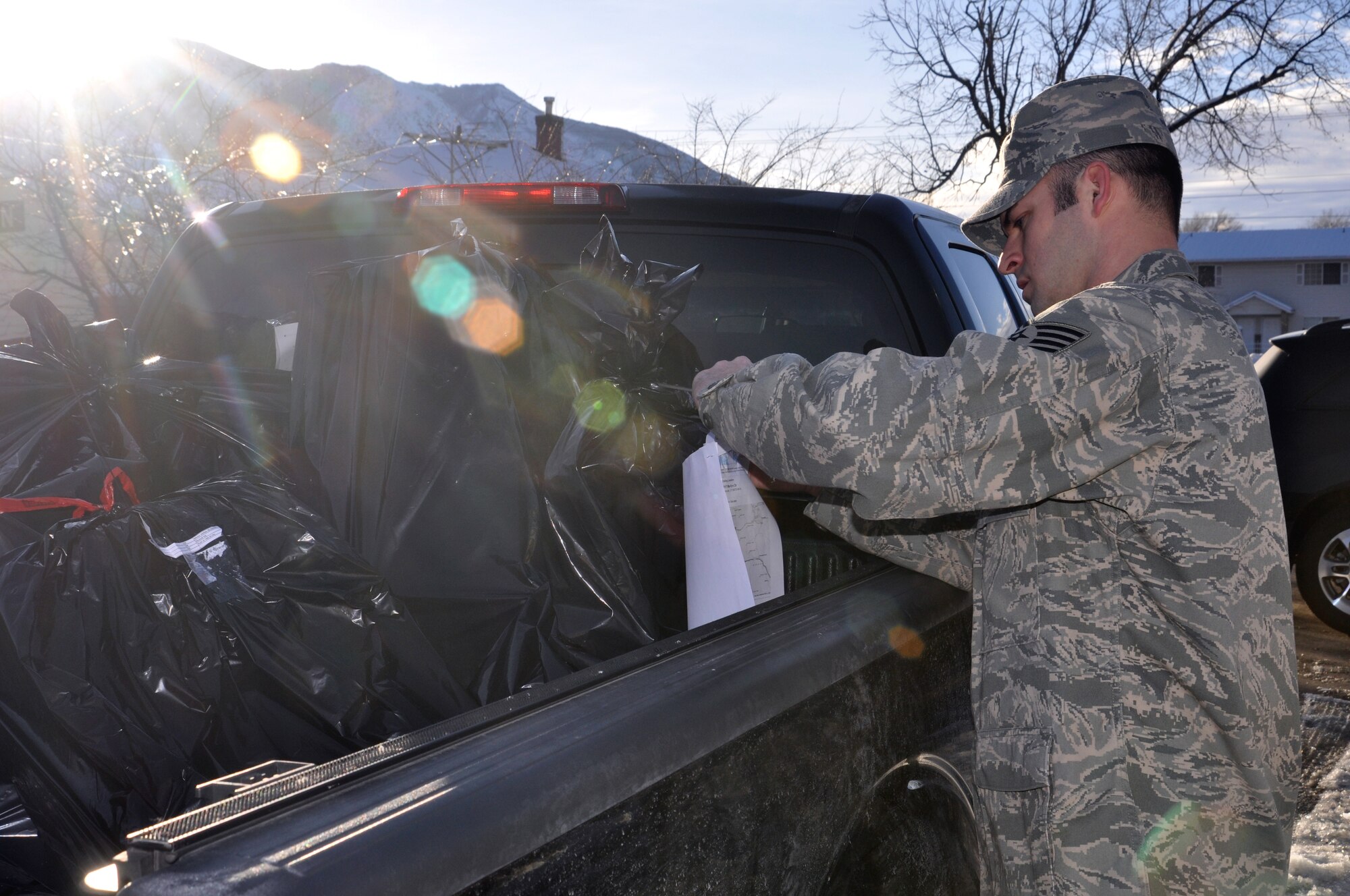 Staff Sgt. Allen Hightower, of the 419th Maintenance Squadron, carefully arranges bags of toys for delivery to local children in foster care Dec. 15. 419th Fighter Wing reservists joined about 60 volunteers from Hill Air Force Base to hand-deliver hundreds of gifts across the Wasatch Front. (U.S. Air Force photo/Bryan Magaña)