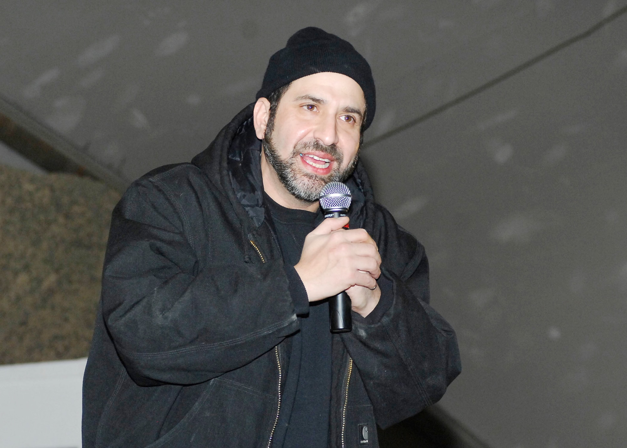Dave Attell entertains the Airmen, Soldiers, Sailors and Marines at Bagram Airfield, Afghanistan, during a United Service Organization tour Dec. 15, 2009. Mr. Attell, Billy Ray Cyrus, Anna Kournikova and Nick Bollettieri are featured in an USO tour boosting the morale of deployed servicemembers. Mr. Attell is a comedian originally from Queens, N.Y. (U.S. Air Force photo/Senior Airman Felicia Juenke)