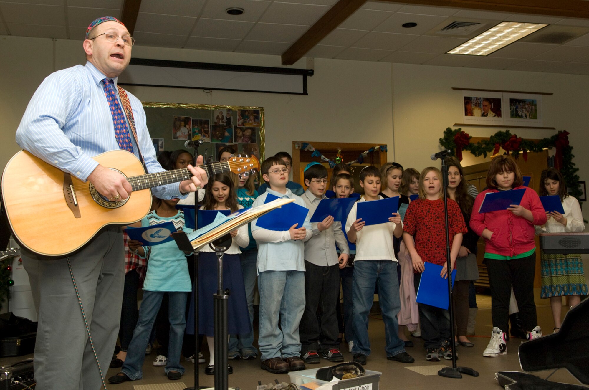 HANSCOM AIR FORCE BASE, Mass. -- Howard Worona (left), Hanscom Middle School music teacher, accompanies the choir during Hanscom's Menorah Lighting Ceremony, held at the Base Chapel on Dec. 14.  (U.S. Air Force photo by Mark Herlihy)