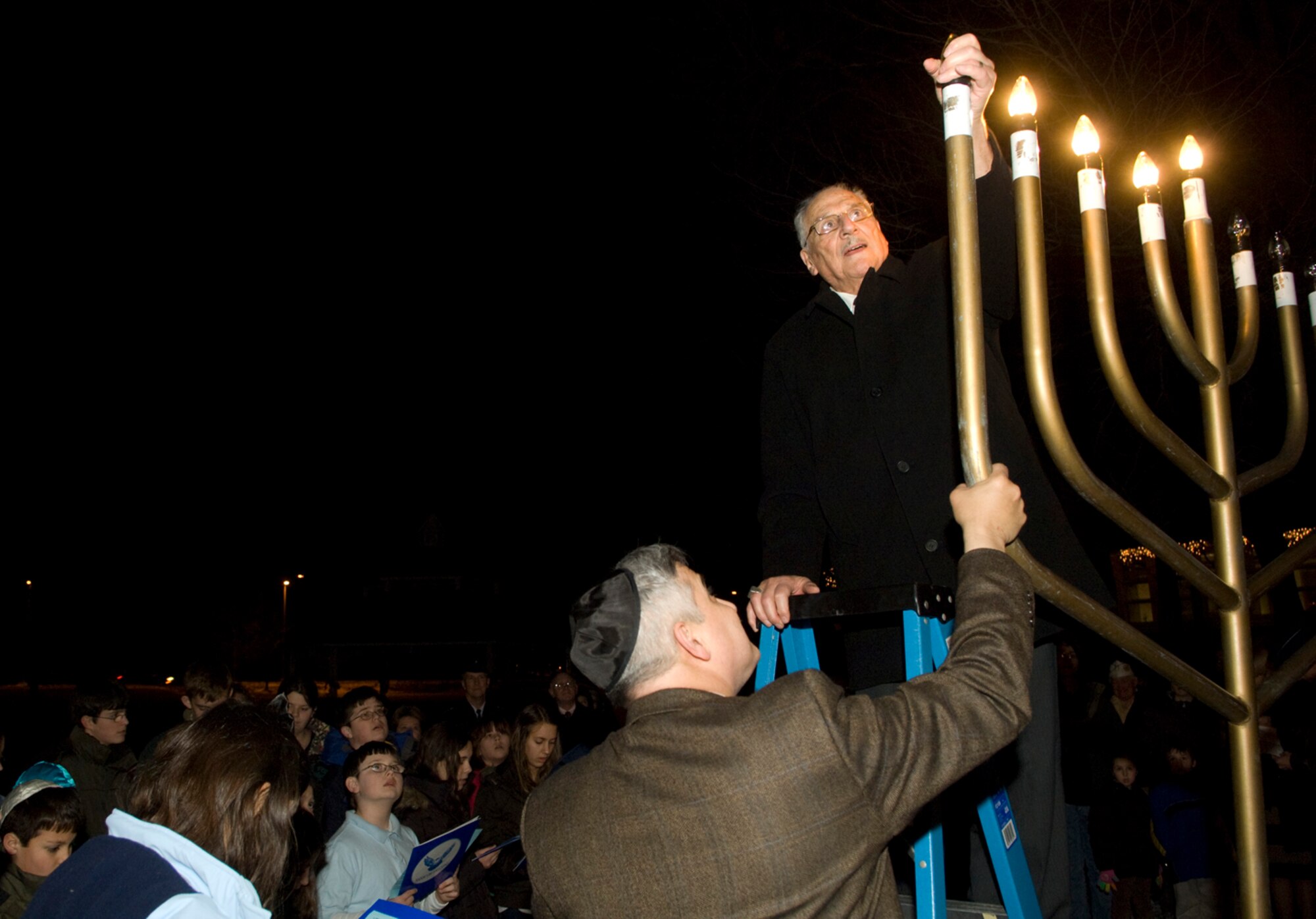HANSCOM AIR FORCE BASE, Mass.-- Rabbi Abraham Morhaim lights Hanscom's Menorah during a ceremony celebrating Hanukkah, the Jewish Festival of Lights, at the Base Chapel on Dec. 14. Hanukkah began Dec. 11 and continues through Dec. 19.  (U.S. Air Force photo by Mark Herlihy) 