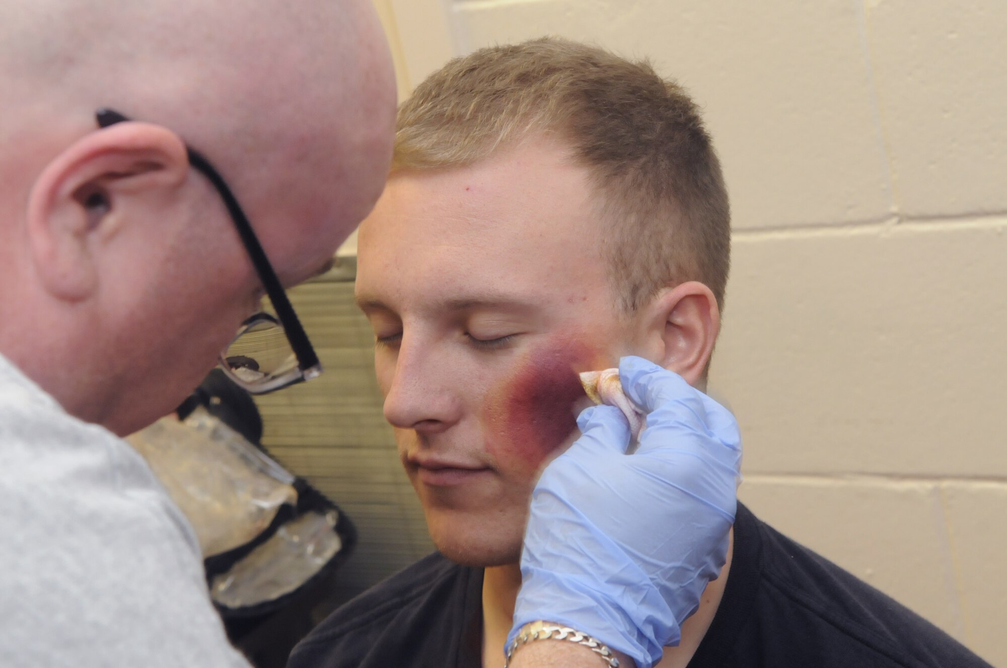 SSgt. Robert Mayner has make-up applied to simulate injuries for an exercise for the Medical Center of Central Georgia. U. S. Air Force photo by Sue Sapp