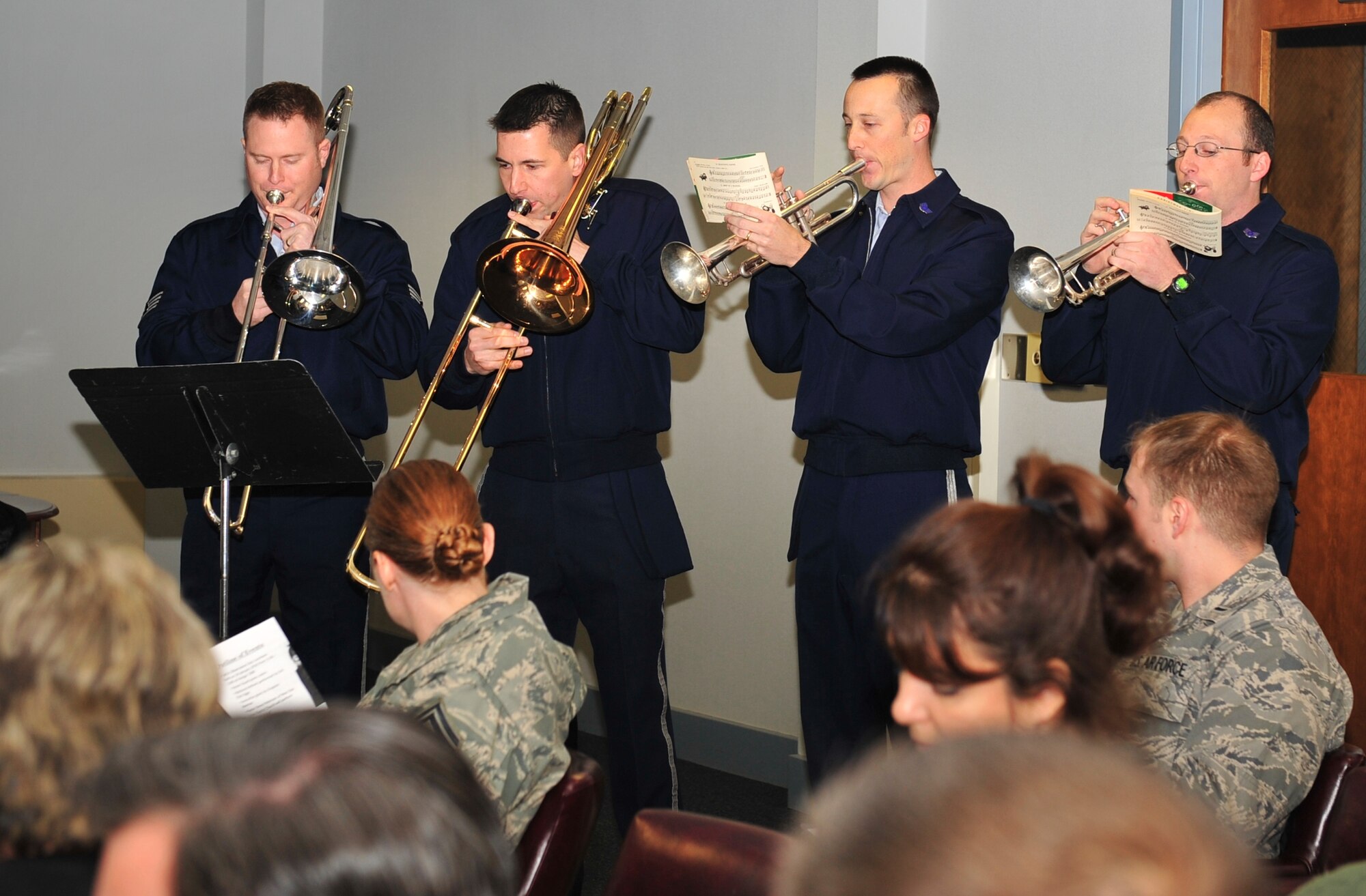 Members of the United States Air Force Band of Mid-America from Scott Air Force Base, Ill., (from left) Staff Sgts. Robert Hyatt, Erik Dahlgren, Scott Dooley, and Ben Peterson, are a caroling quartet here to spread holiday cheer to Little Rock Air Force Base members Dec 16. The United States Air Force Band of Mid-America is the principal musical ambassador of Headquarters Air Mobility Command. (U.S. Air Force photo by Airman 1st Class Lausanne Pacheco)