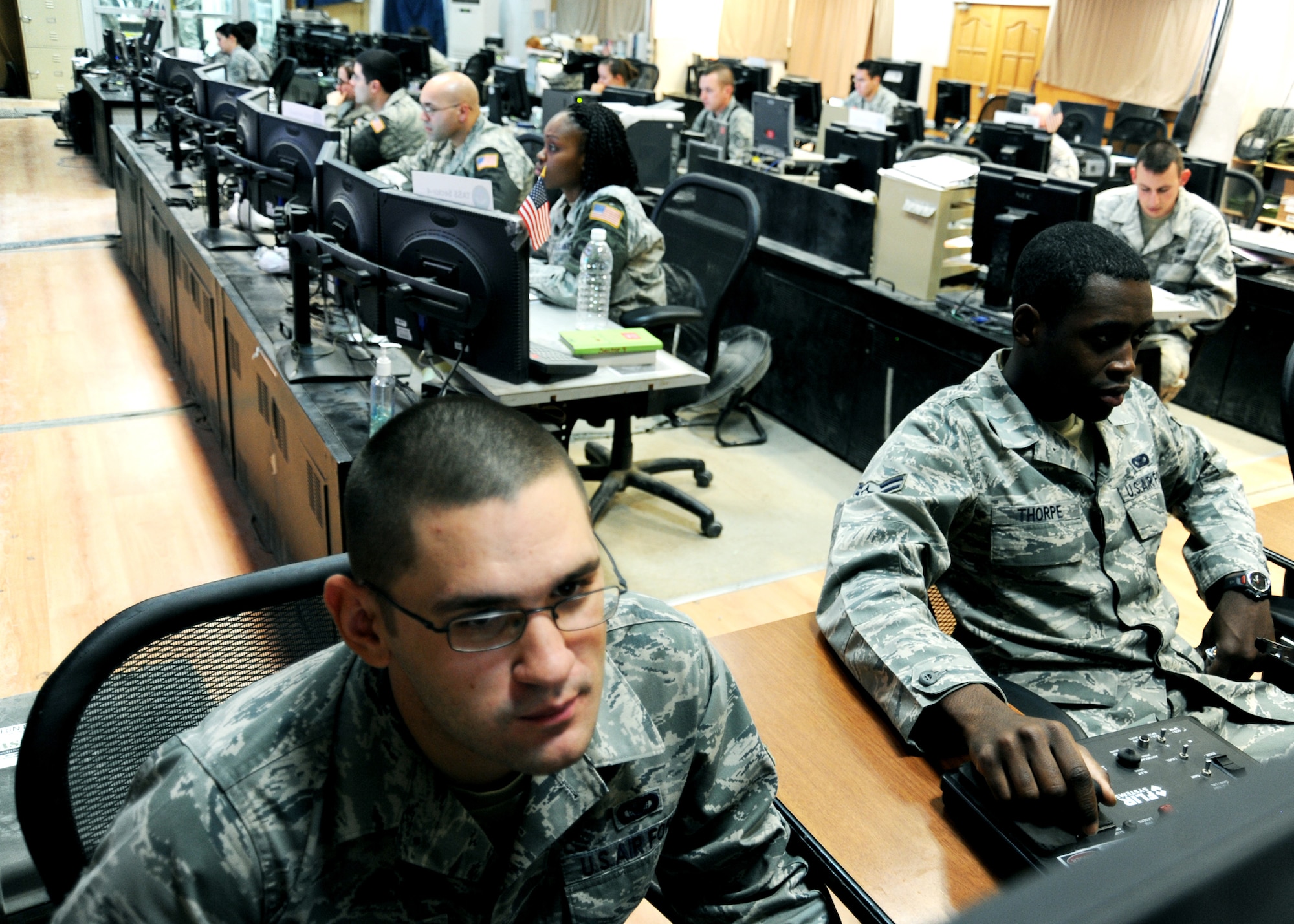 JOINT BASE BALAD, Iraq -- Airmen of the 332nd Expeditionary Security Forces Squadron monitor computer screens in the joint defense operations center Nov. 10, 2009, checking for anything suspicious in their assigned areas. Airmen who work at the JDOC help provide intelligence and real-time situational awareness of the areas surrounding Joint Base Balad. (U.S. Air Force photo/Senior Airman Christopher Hubenthal)