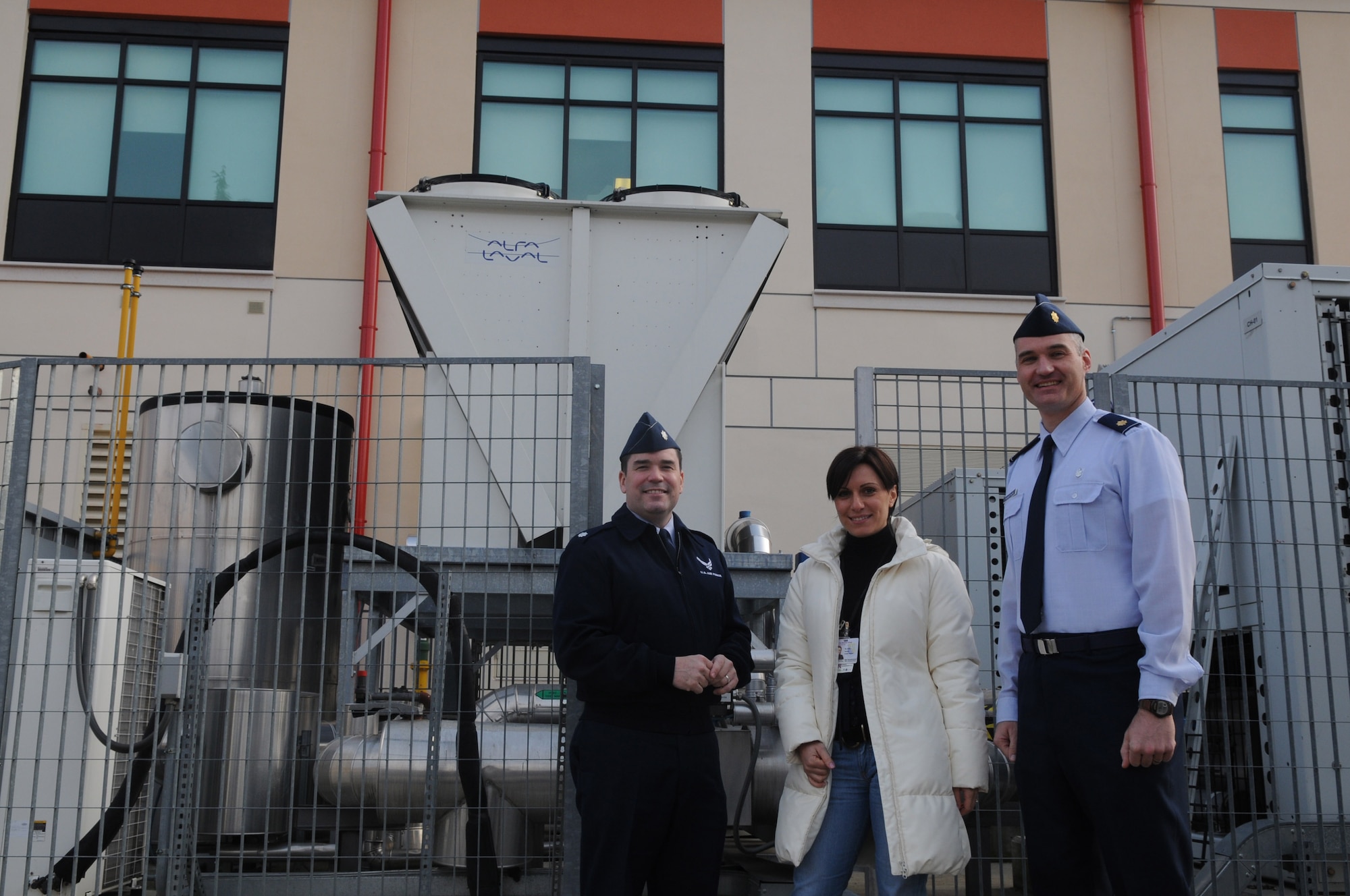 Lt. Col. John Savage, 31st Medical Support Squadron commander, Manuela Solda, 31st Medical facility manager and Maj. James Robertson, 31st MDSS medical logistics flight commander, stand in front of the equipment that earned them the ENERGY STAR recognition.  Aviano hospital recently received the Environmental Protection Agency's ENERGY STAR rating. The rating is a national symbol for superior energy and environmental protection.  (U.S. Air Force photo/Staff Sgt. Mercedes Crossland) 