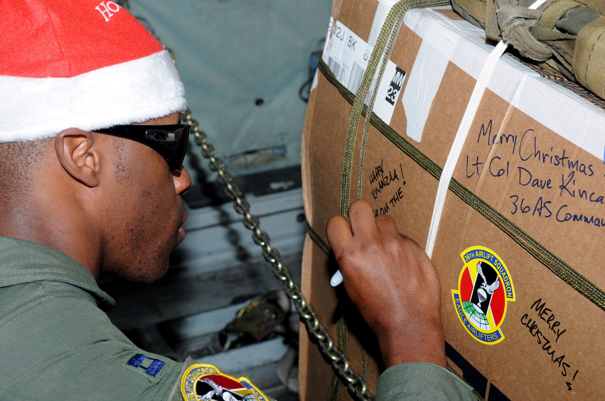 ANDERSEN AIR FORCE BASE, Guam - Captain Adam Cole, 36th Airlift Squadron pilot, writes a holiday greeting to the recipients of one of the boxes packed in support of Operation Christmas Drop Dec. 17. The operation, which began in 1952, is the Air Force?s longest-running humanitarian mission. Airmen today continue the tradition delivering supplies to remote islands of the Commonwealth of the Northern Marianas Islands, Yap, Palau, Chuuk and Pohnpei.   (U.S. Air Force Photo by Airman 1st Class Julian North)