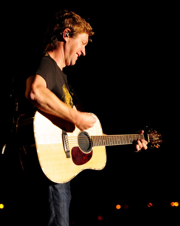 ANDERSEN AIR FORCE BASE, Guam - Craig Morgan strums the guitar in front of fans here Dec. 15. Craig Morgan, one of country music artists and an Army veteran, is visiting, entertaining and kicking off the holidays with troops and their families stationed in Guam and Okinawa as part of a week-long USO/Armed Forces Entertainment tour. (U.S. Air Force photo by Airman 1st Class Courtney Witt)

