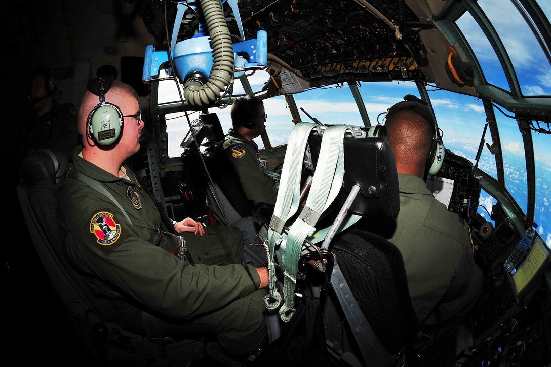 CHUUK, Commonwealth of the Northern Marianas Islands ? Col.  Mark Herring, 374th Operations Group Commander and pilot, Capt. Adam Col, 36th Airlift Squadron co-pilot, and SSgt Josh Plant, 36th Airlift Squadron flight engineer, fly a C-130 Hercules over back to Andersen Air Force Base, Guam after dropping bundles of donated goods over the Chuuk islands during Operation Christmas Drop Dec. 16. Operation Christmas Drop, the longest running humanitarian airlift mission in the world, delivers supplies to remote islands of the Commonwealth of the Northern Marianas Islands of Yap, Palau, Chuuk and Pohnpei. (U.S. Air Force photo/Tech. Sgt. Kimberly Spinner)