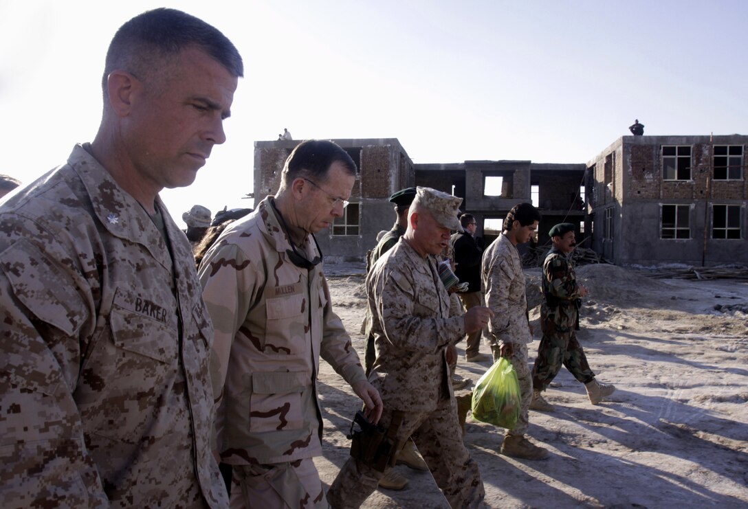 Marine Corps Lt. Col. Matt Baker, Navy Adm. Mike Mullen and Marine Corps Brig. Gen. Lawrence D. Nicholson walk past the Nawa governance center near Patrol Base Jaker in Afghanistan’s Helmand province, Dec. 17, 2009. U.S. Marine Corps photo by Sgt. Brian Tuthill