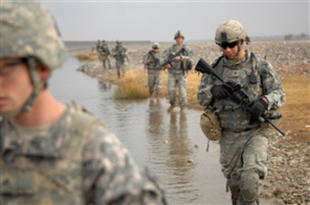 U.S. Army Sgt. John Clayton, with 2nd Battalion, 508th Parachute Infantry Regiment, 82nd Airborne Division, makes his way through a river while on a joint patrol with soldiers from Charlie Company, 1st Battalion, 17th Infantry Regiment, 5th Stryker Brigade Combat Team, 2nd Infantry Division in the Arghandab River Valley of Kandahar province, Afghanistan, on Dec. 13, 2009.  