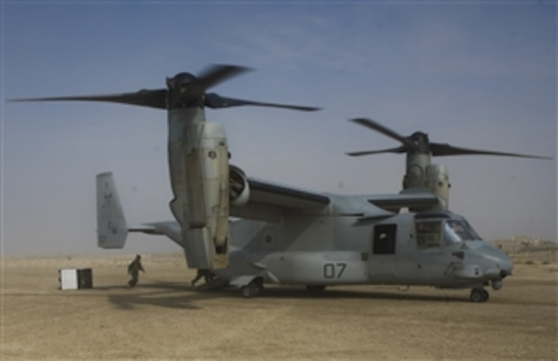 U.S. Marines with Marine Expeditionary Brigade-Afghanistan, push boxes out the back of a V-22 Osprey aircraft in Zaranj, Afghanistan, on Dec. 14, 2009.  The Expeditionary Brigade Marines are conducting a supply drop to support the Afghan Uniformed Police.  