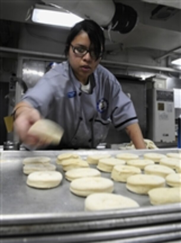 U.S. Navy Seaman Lindsey Ocampo prepares breakfast pastries in the bakery aboard the aircraft carrier USS John C. Stennis (CVN 74) while the ship is underway in the Pacific Ocean on Dec. 10, 2009.  The Stennis is conducting carrier qualifications for fleet replacement squadron pilots off the coast of southern California.  