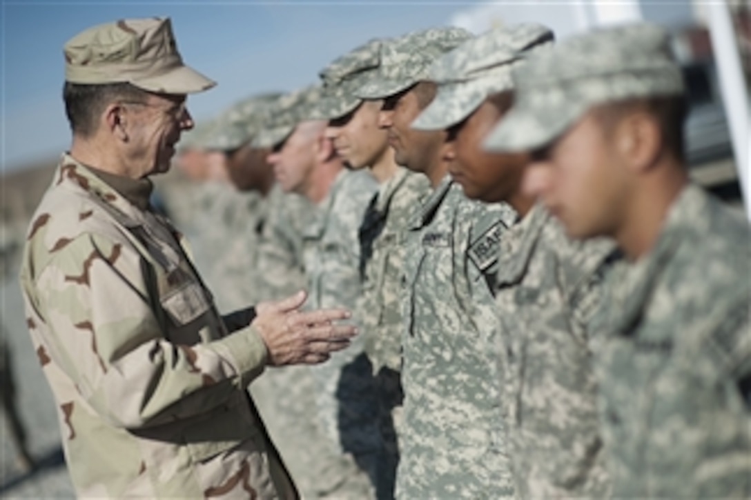 Chairman of the Joint Chiefs of Staff Adm. Mike Mullen, U.S. Navy, reenlists ten soldiers assigned to 5/2 Stryker Brigade stationed at Forward Operating Base Frontenac in Kandahar, Afghanistan, on Dec. 17, 2009.  