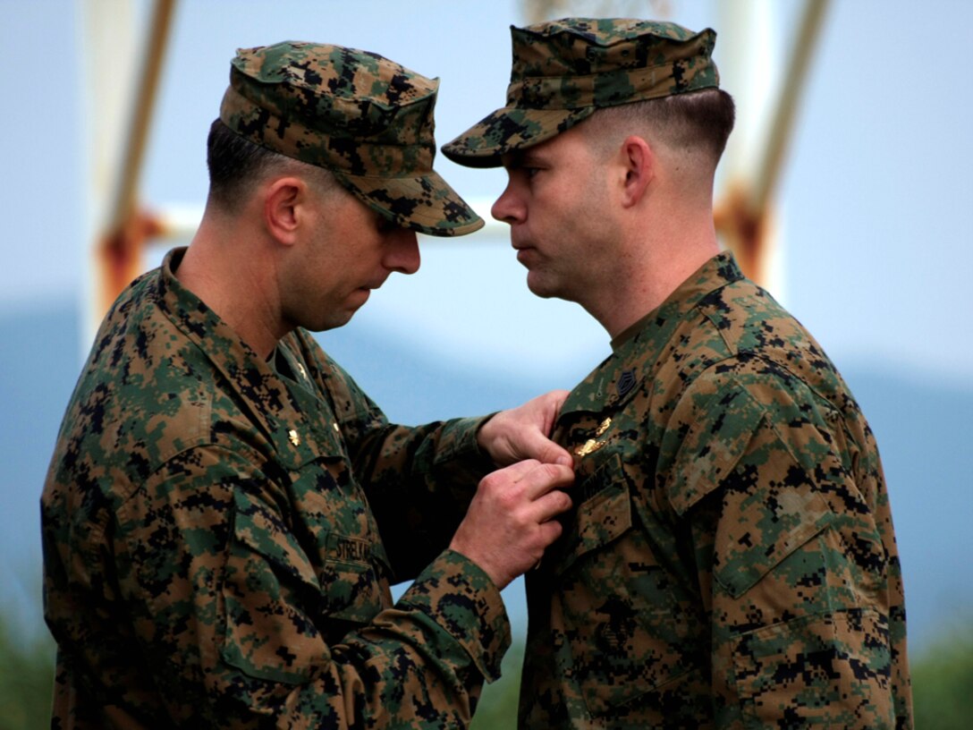 Gunnery Sgt. John S. Mosser is awarded the Navy Cross during a ceremony at Recon Point in Camp Schwab Dec. 18 by Maj. Danny Strelkauskas,  currently the commanding officer of Force Company, 1st Reconnaissance Battalion, 1st Marine Division, I Marine Expeditionary Force. Mosser was  awarded the Navy Cross for actions in Afghanistan during June 2008.