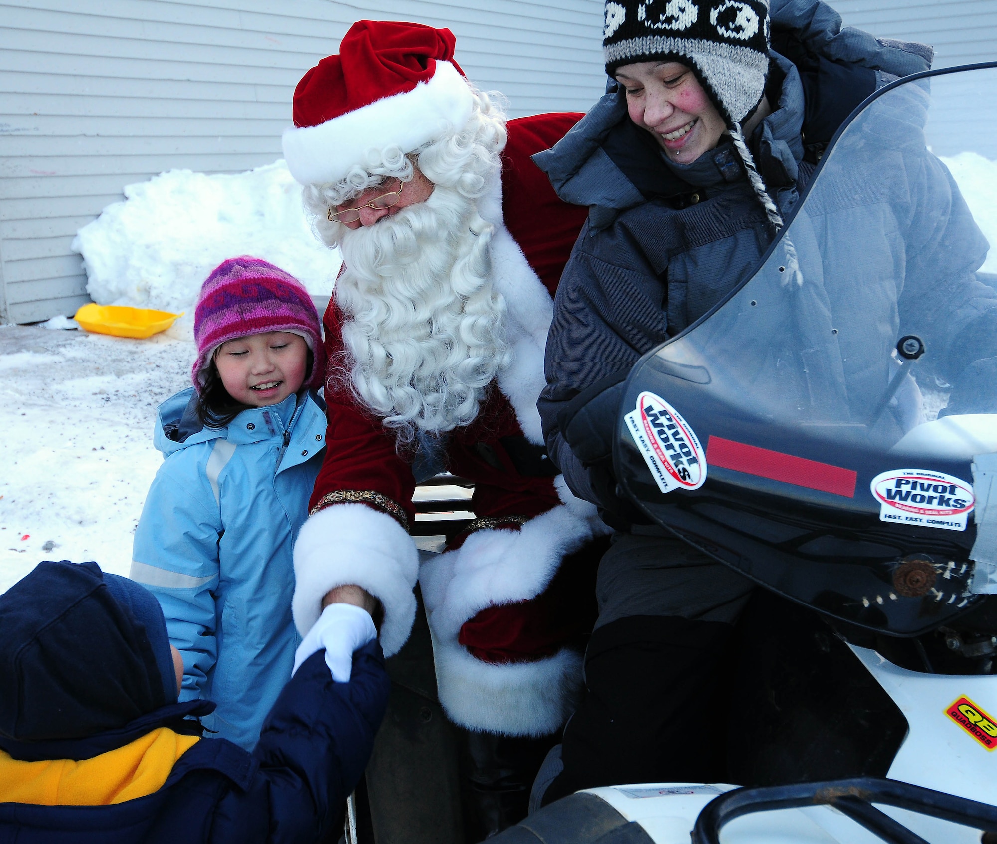 Santa bids goodbye to Gambell children after a visit to the Gambell Public School on Dec. 16, 2009. The Alaska Air and Army National Guard visited Gambell, on remote St. Lawrence Island in the Bering Sea, with Santa and a group of civilian volunteers as part of Operation Santa Claus. Now in its 53rd year, Operation Santa Claus is a program of the Alaska National Guard to bring toys, food, supplies and Christmas cheer to isolated villages around the state. Alaska Air National Guard photo by 1st. Lt. John Callahan.