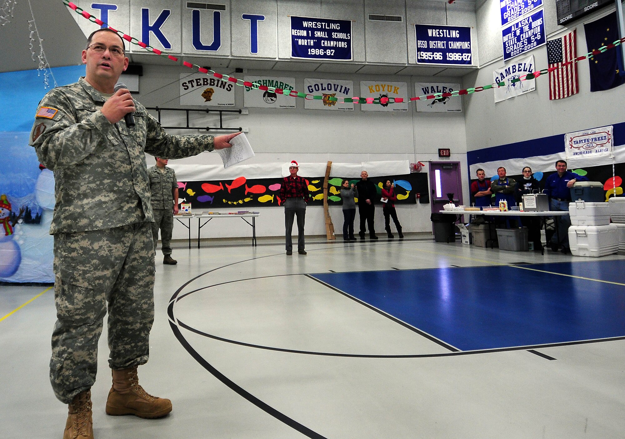 Brig. Gen. Randy Banez, assistant adjutant general for the Alaska Army National Guard, speaks to schoolchildren at Gambell Public School on Dec. 16, 2009. The Alaska Air and Army National Guard were in Gambell, on remote St. Lawrence Island in the Bering Sea, with a group of civilian volunteers as part of Operation Santa Claus. Now in its 53rd year, Operation Santa Claus is a program of the Alaska National Guard to bring toys, food, supplies and Christmas cheer to isolated villages around the state. Alaska Air National Guard photo by 1st. Lt. John Callahan.