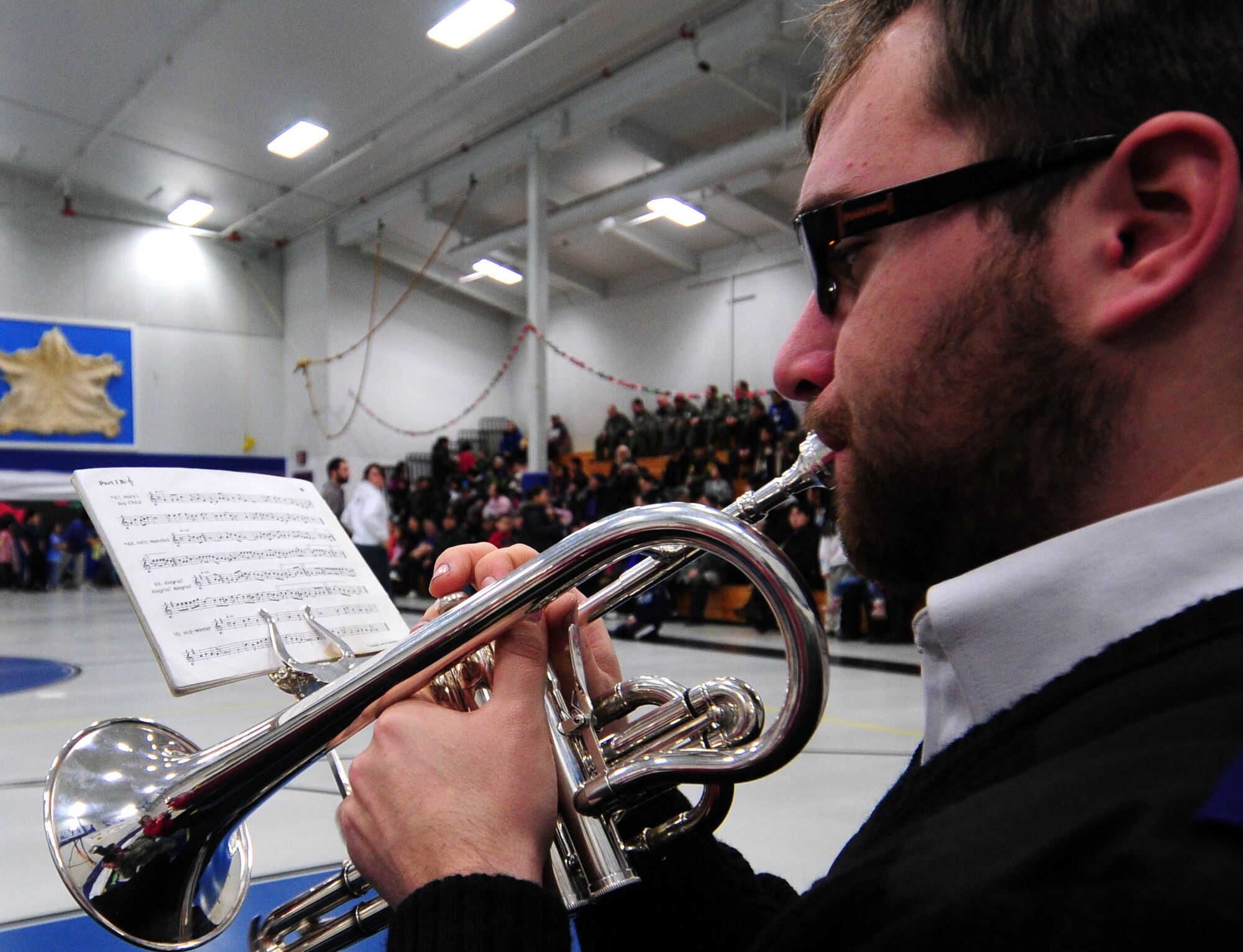 Trumpeter David Tollerud, a member of the Salvation Army Band, plays for assembled Gambell residents in the gymnasium of Gambell Public School on Dec. 16, 2009. The Salvation Army is a major supporter of Operation Santa Claus. Now in its 53rd year, Operation Santa Claus is a program of the Alaska National Guard to bring toys, food, supplies and Christmas cheer to isolated villages around the state. Alaska Air National Guard photo by 1st. Lt. John Callahan.