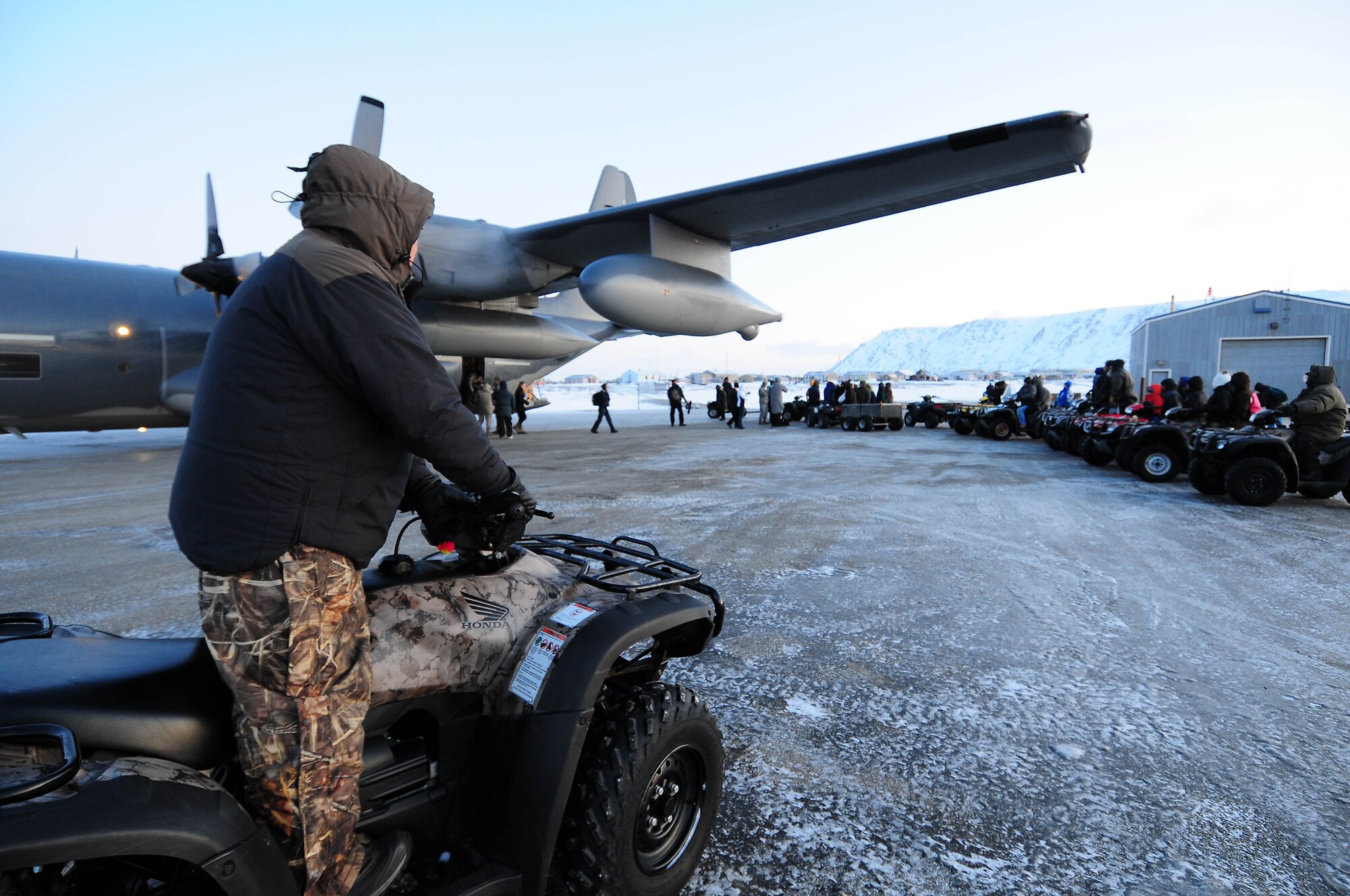 Gambell resident Gerry Koonooka Sr. waits with the rest of the Operation Santa Claus reception committee for the offloading of an Alaska Air National Guard HC-130 aircraft Dec. 16, 2009. The Alaska Air and Army National Guard were in Gambell with a group of civilian volunteers as part of Operation Santa Claus 2009. Operation Santa Claus is a 53-year program of the Alaska National Guard to bring toys, food, supplies and Christmas cheer to isolated villages around the state. Alaska Air National Guard photo by 1st. Lt. John Callahan.
