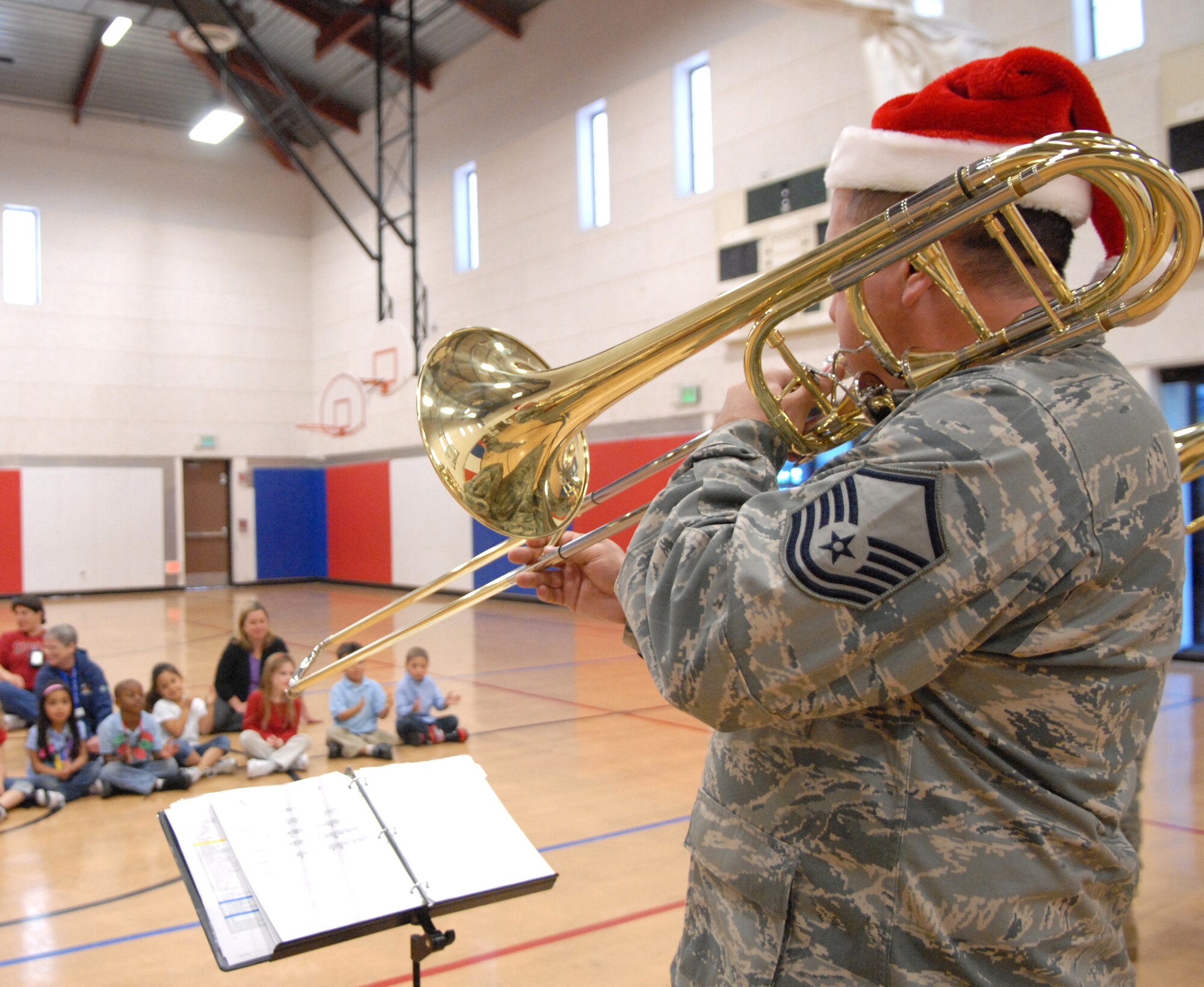 VANDENBERG AIR FORCE BASE, Calif. -- Master Sgt. Matthew Baloun, a member of the Band of the Golden West from Travis AFB, Calif., plays the brass trombone for the children of the school-age daycare class at the Youth Center Thursday, Dec. 17, 2009, here.  The band toured main base and played holiday songs for members of Vandenberg. (U.S. Air Force photo/Airman 1st Class Kerelin Molina)