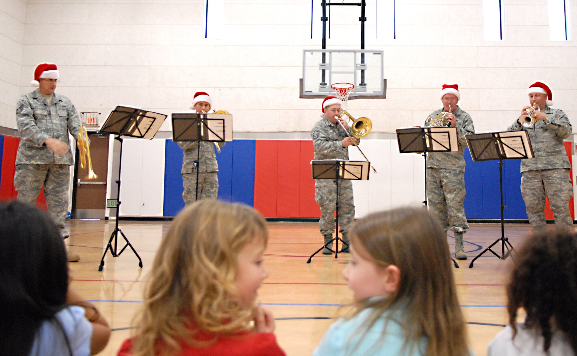 VANDENBERG AIR FORCE BASE, Calif. -- Bringing a bit of Christmas cheer to the children from the school-age daycare class at the Youth Center, the Band of the Golden West from Travis AFB, Calif., plays Christmas carols Thursday, Dec. 17, 2009, here.The band toured main base and played holiday songs to members of Vandenberg. (U.S. Air Force photo/Airman 1st Class Kerelin Molina)