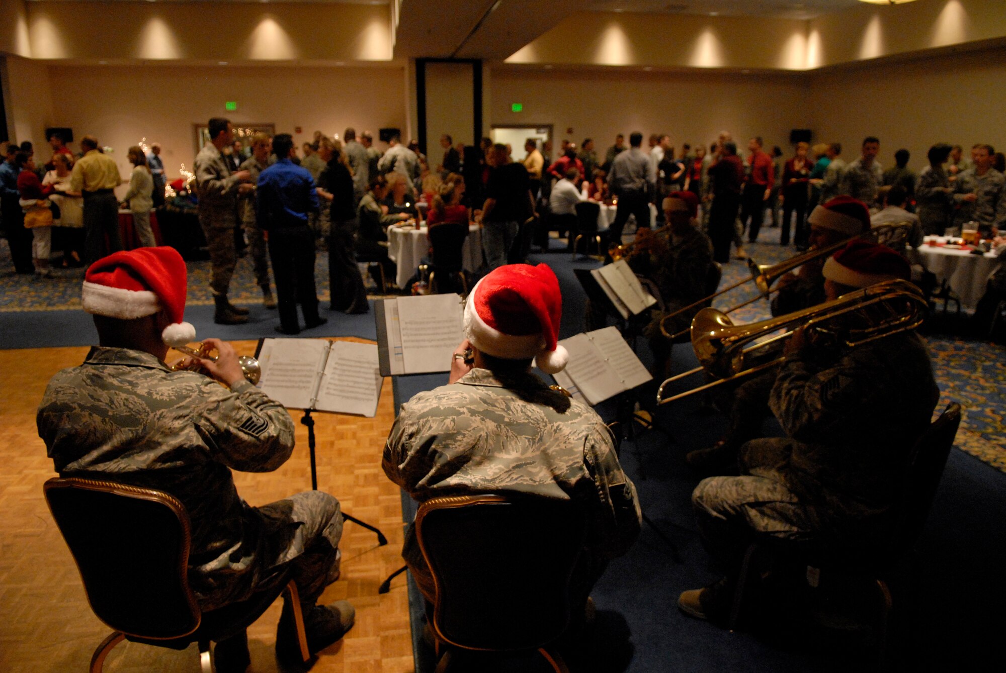 VANDENBERG AIR FORCE BASE, Calif. -- As Team V mingles, members of the Band of the Golden West perform Christmas songs during the 30th Space Wing Holiday Social here Thursday, Dec. 17, 2009. The band, which is stationed at Travis AFB, Calif., traveled around Vandenberg to play holiday music for the base. (U.S. Air Force photo/Staff Sgt. Benjamin Rojek)