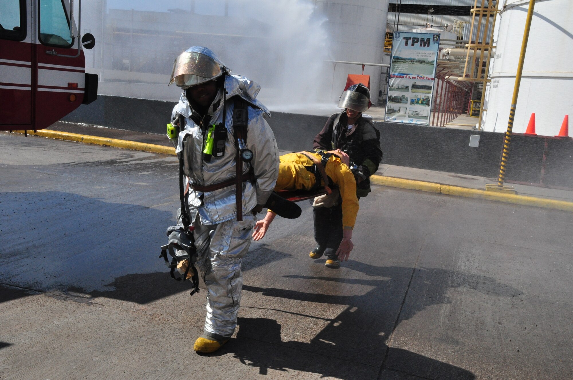 Staff Sgt. Brandon Johnson and a member of the Comayagua fire department carry a dummy simulating a fire victim from the scene of a tank fire at the Unilever Industrial Plant near Comayagua Dec. 18, 2009. Sergeant Johnson was part of a combined exercise between U.S. and Honduran firefighters designed to increase their capabilities in working together. (U.S. Air Force photo/Tech. Sgt. Mike Hammond)