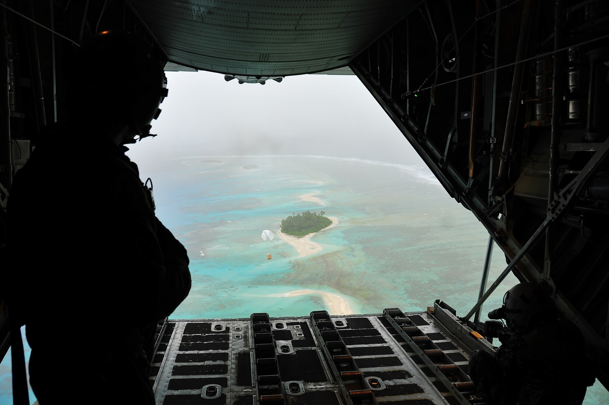 A bundle of donated goods drifts to an island after being dropped out the back of a C-130 Hercules Dec. 16, 2009, during Operation Christmas Drop.  The operation, the longest-running humanitarian airlift mission in the world, delivers supplies to remote islands of the Federated States of Micronesia. (U.S. Air Force photo/Tech. Sgt. Kimberly Spinner)