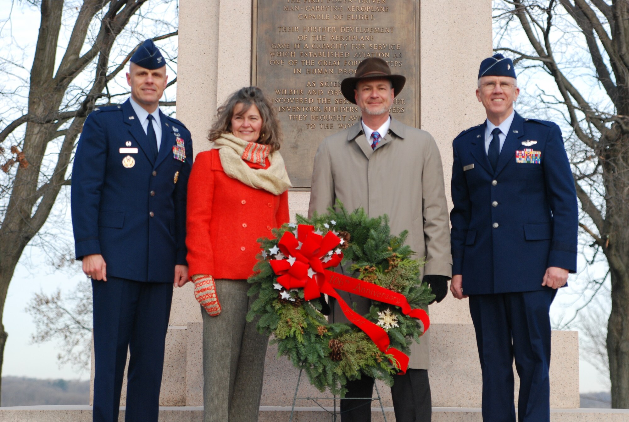 Members of the Wright Family and Wright-Patterson Air Force Base placed a wreath at the Wright Brothers Memorial Dec. 17, 2009 during a ceremony marking the 106th anniversary of the Wright Brothers' first powered flight. Amanda Wright Lane, great grand-niece of the brothers and Stephen Wright, great grand-nephew, pose with Col. Brad Spacy (l) and Brig. Gen. Paul Sampson (r).  Col. Spacy is 88th Air Base Wing commander, and Brig. Gen. Sampson is mobilization assistant to the commander of Aeronautical Systems Center. (U.S. Air Force photo/Bonnie White)