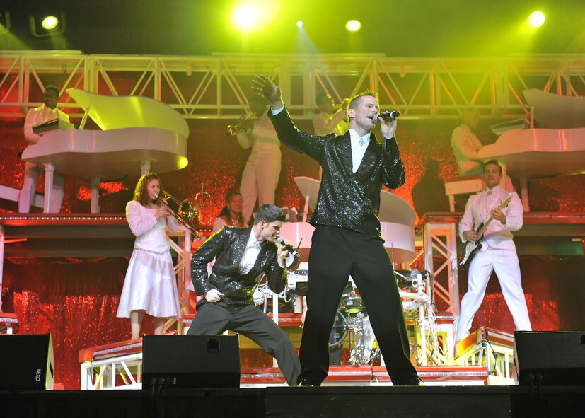 Singers Robert Kalert, left, and Timothy Womble, right, both staff sergeants, work together on a number during Tops In Blue Dec. 10. Sergeant Kalert is from Shaw AFB, S.C. and Sergeant Womble is stationed at Charleston AFB, S.C. (U.S. Air Force photo/John Turner)