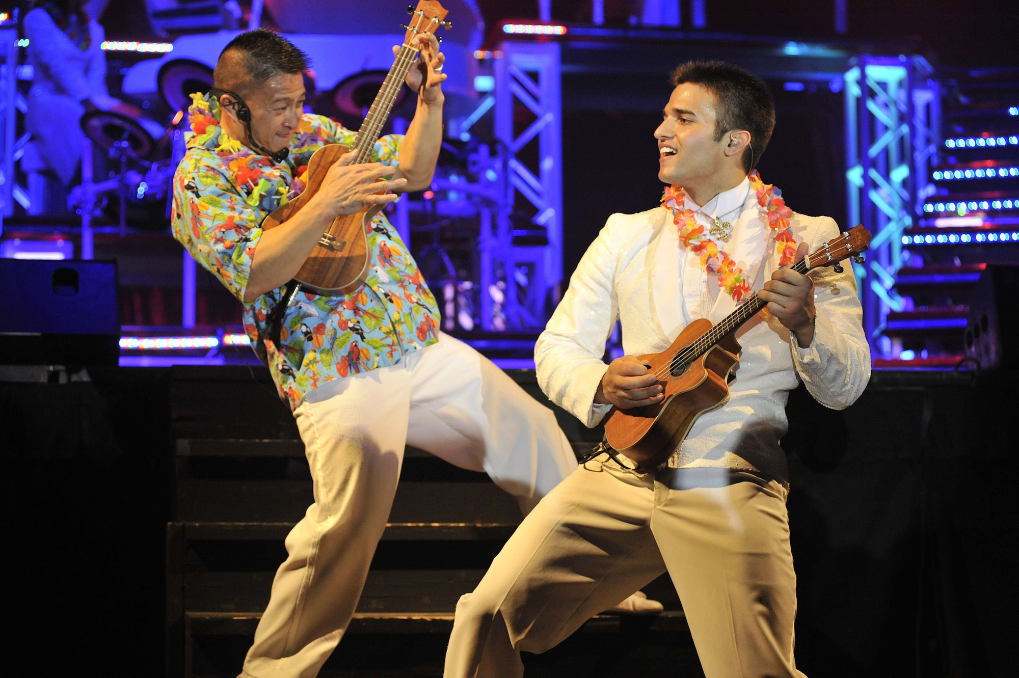 Master Sgt. Herbert Ancog, left, and Senior Airman Shane Jones get into a Hawaiian musical number as part of the Tops in Blue show Dec. 10. Sergeant Ancog also doubles as the troupe's first sergeant and is stationed at Lackland Air Force Base, Texas. Airman Jones is currently stationed at Hickham AFB, Hawaii. (U.S. Air Force photo/John Turner)