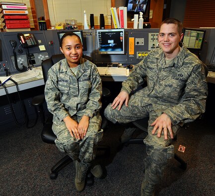 OFFUTT AIR FORCE BASE, Neb. - Staff Sgt. Waymie Williams-Brandt (left) and Tech. Sgt. Joseph H. Brandt (right) both 55th Wing Command Post senior emergency action controllers, sit inside the command post here Dec. 18. The sergeants, who've been married for the past five years, are expecting their first child in July 2010. As command post controllers, they're responsible for initiating an alert recall, notifying base agencies of emergencies and advising Offutt's senior leaders. U.S. Air Force Photo by Josh Plueger