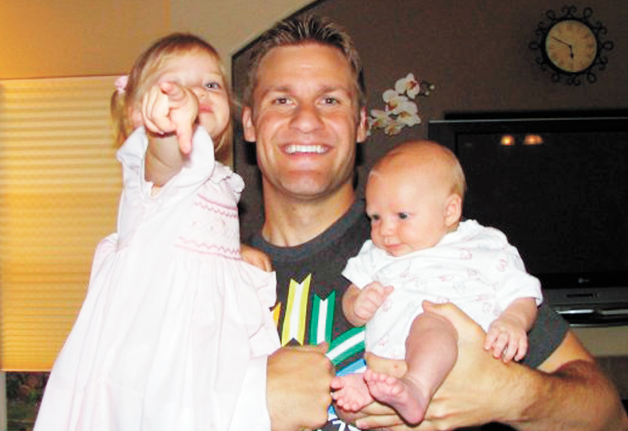 Capt. Jesse Goolsby poses for a photo with his two daughters in this photo taken in the Goolsbys' home. The captain's most recent work, a short story called "Thirteen Steps," is scheduled to be published in Storyglossia magazine in February. (U.S. Air Force photo)