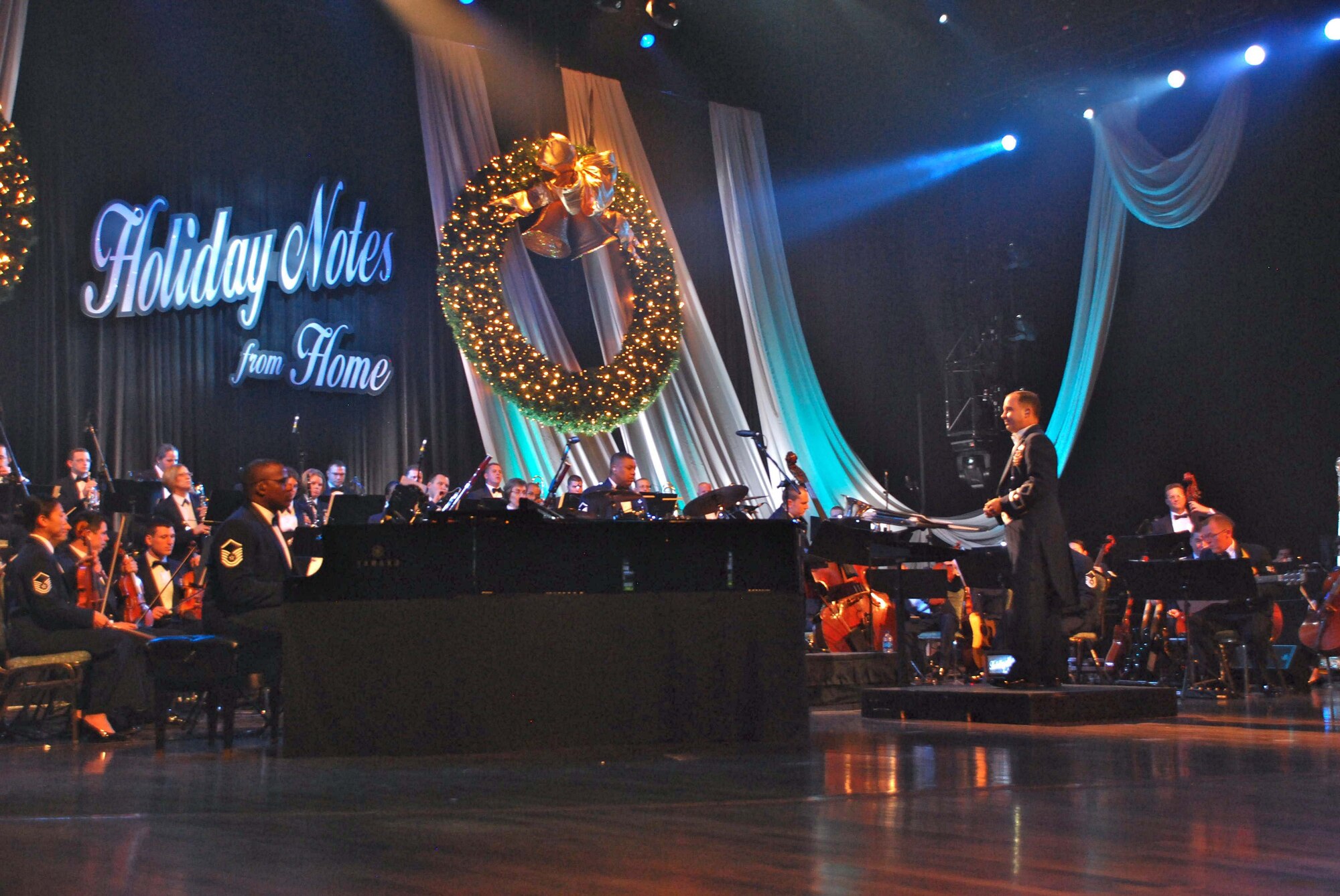 Band of the Air Force Reserve commander Maj. Donald Schofield leads the 60-member orchestra during the 2009 Holiday Notes from Home taped concert Oct. 26 at the Grand Ole Opry House in Nashville. The annual holiday concert, featuring Amy Grant, Brian McKnight, Take 6, Band of the Air Force Reserve and Air Force Strings ensemble, will broadcast on Gospel Music Channel and American Forces Network. (U.S. Air Force/Ken Hackman)