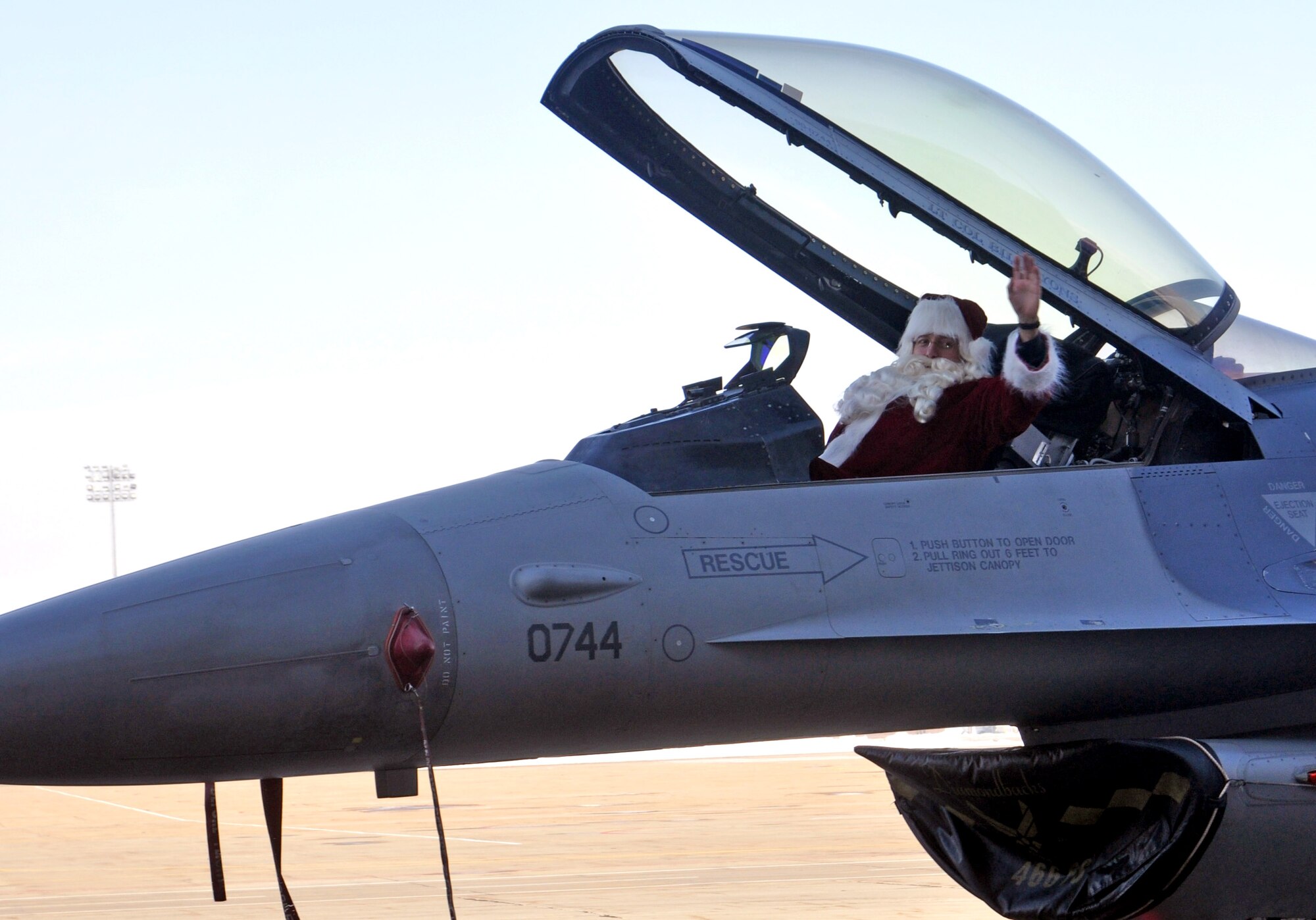 Santa, played by 419th Fighter Wing Commander Col. Walter “Buck” Sams, arrives at the wing’s annual Christmas party in an F-16 Dec. 17. (U.S. Air Force photo/Bryan Magaña)