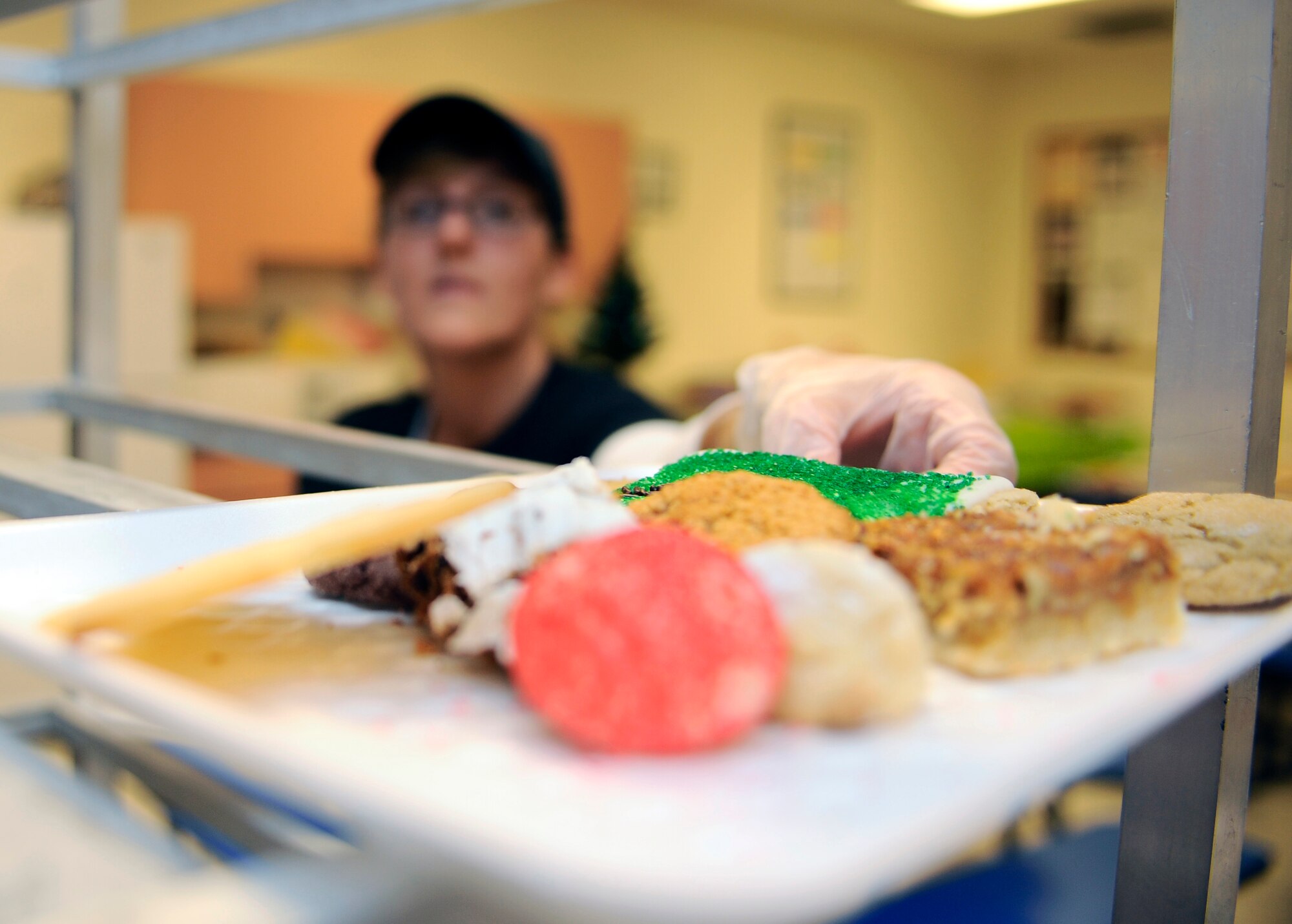 HOLLOMAN AIR FORCE BASE, N.M. -- Sundy Keichel, wife of Capt. William Keichel, 781 Test Squadron, stacks trays filled with a dozen cookies during the Cookie Drive held at the base commissary here, Dec. 14. After wrapping the cookie trays, first sergeants from each squadron helped deliver them to Airmen. Leftover cookies went to the base chapel to continue the giving of cookies. (U.S. Air Force photo by Airman 1st Class Veronica Stamps)