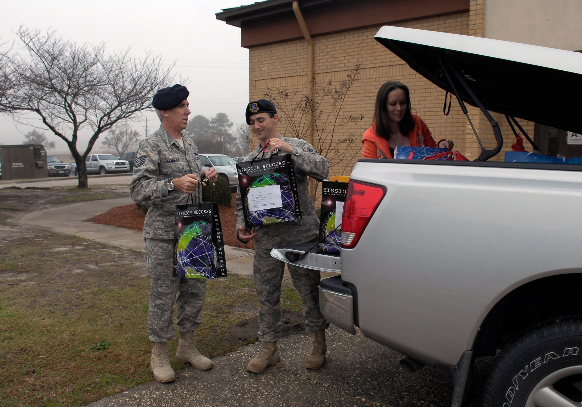 Members of the 43rd Security Forces Squadron and Cumberland County Department
of Social Services pose after unloading more than 200 presents donated by personnel
at Pope who donated gifts selected from a wish list made by the underprivileged
children under the care of the CCDSS. (U.S. Air Force photo/Senior Airman Kris Levasseur)
