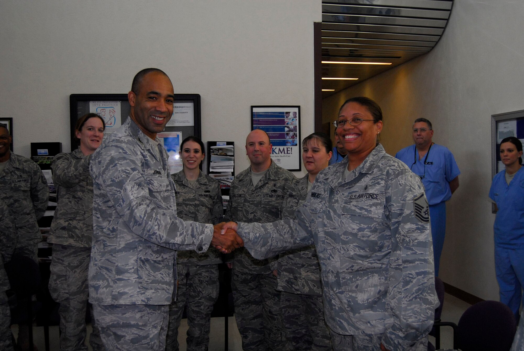 Col. James Johnson, 43rd Airlift Wing Commander, presents Master Sgt. 
Davonna Chambers, 43rd Aerospace Medical Squadron, a Commander’s 
Coin in the Pope Dental Clinic. 
