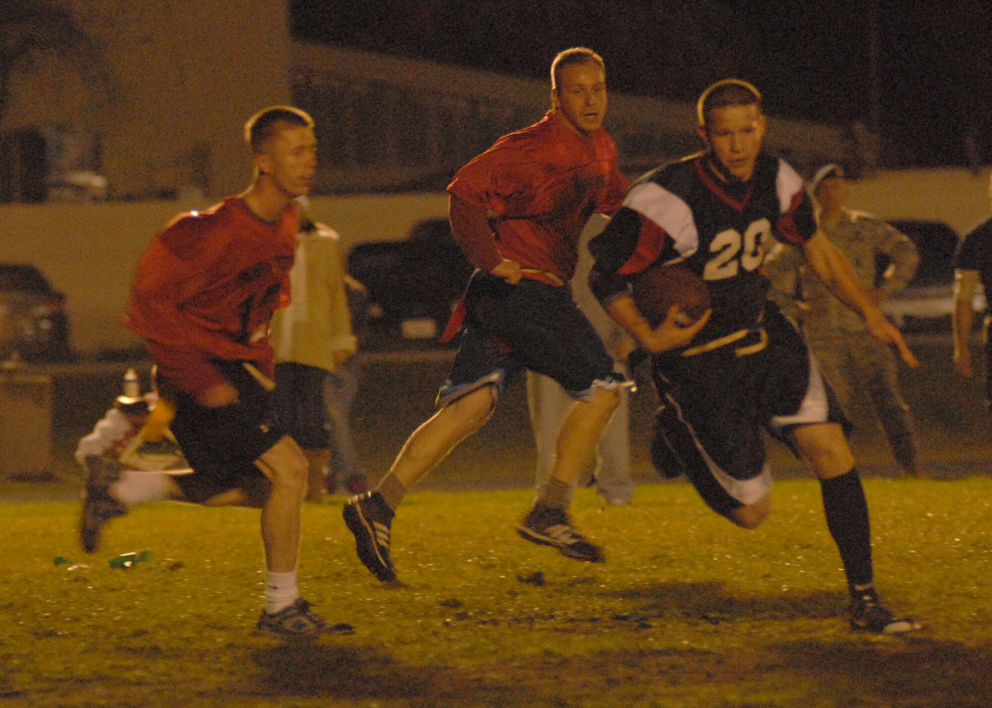 VANDENBERG AIR FORCE BASE, Calif. -- Courtney Corral, the 30th Security Forces Squadron team quarterback, runs past the defensive line of the 532nd Training Squadron team during an intramural flag football game Tuesday, Dec. 15, 2009, here. The 30th SFS won the match-up 21-6. The game was round one of the losers’ bracket playoff. (U.S. Air Force photo/Airman 1st Class Kerelin Molina)