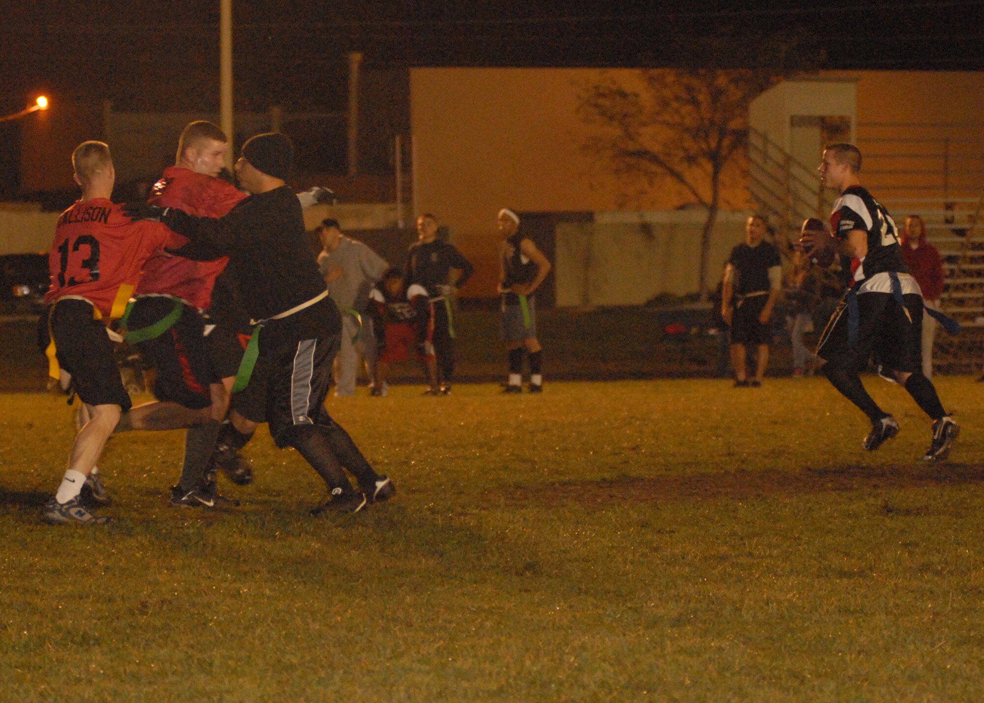 VANDENBERG AIR FORCE BASE, Calif. -- Courtney Corral, the 30th Security Forces Squadron team quarterback, scrabbles in the backfield to find an open receiver during an intramural flag football game Tuesday, Dec. 15, 2009, here versus the 532nd Training Squadron. The 30th SFS won the match-up 21-6.The game was round one of the losers’ bracket playoff game. (U.S. Air Force photo/Airman 1st Class Kerelin Molina)