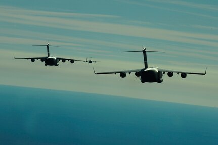 A formation of C-17 aircraft from Charleston Air Force Base, S.C., rally over the Atlantic ocean for refueling while conducting Operation Thunderstruck Dec. 16, 2009. The operation was a large formation exercise utilizing 10 C-17 aircraft and more than 300 participants from the Air Force and Army. Soldiers from the 2-319th Airborne Field Artillery, 82nd Airborne Division, Ft. Bragg, N.C., were airdropped along with cargo pallets to simulate the seizure of a remote airfield.
(U.S. Air Force photo/Staff Sgt. Andy Kin)(Released)
