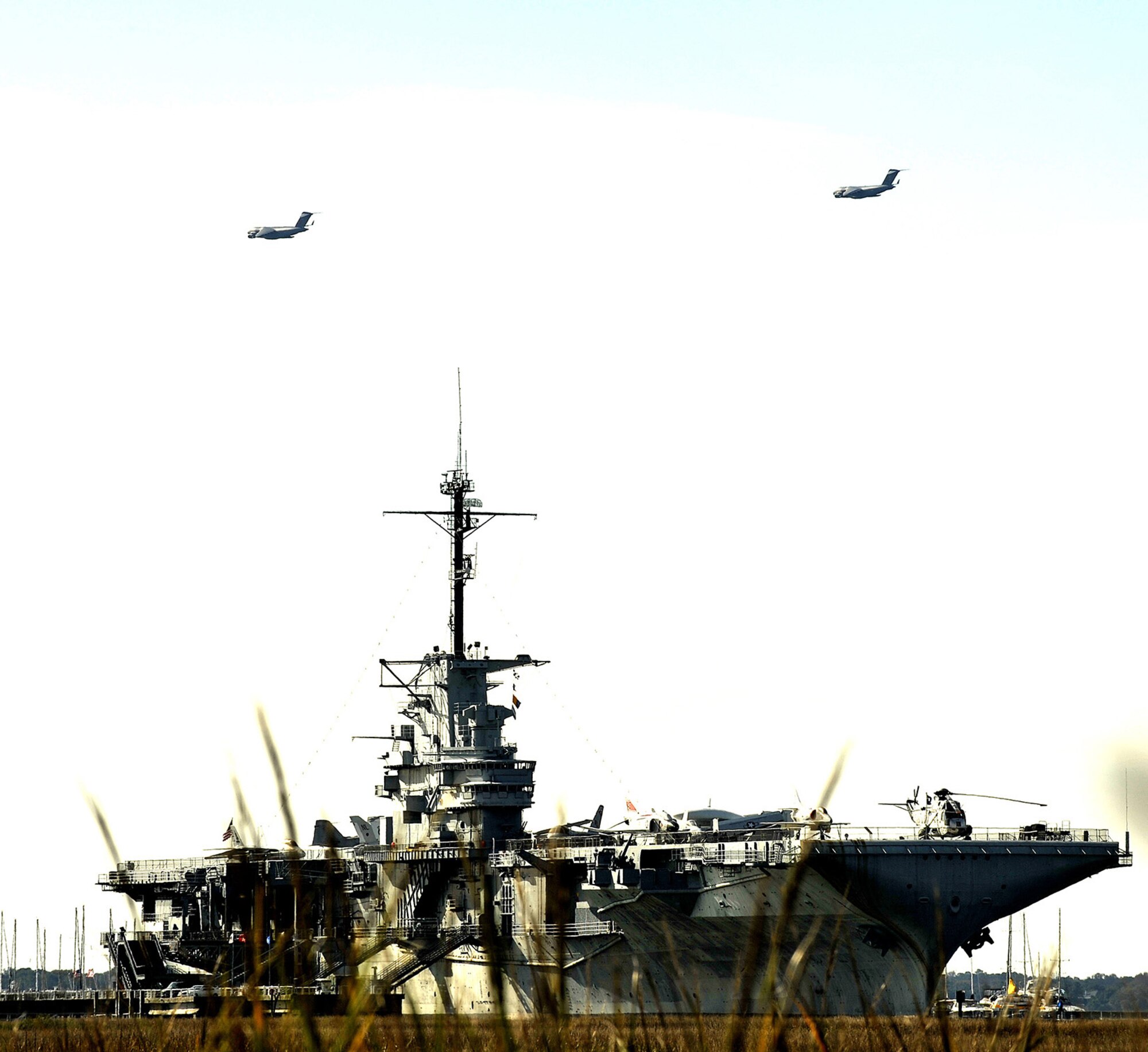U.S. Air Force C-17 aircraft pass over the USS Yorktown Naval and Maritime Museum in Charleston, S.C., Dec. 16, 2009. Charleston AFB conducted a large formation exercise utilizing 10 C-17 aircraft. During the exercise U.S. Army Soldiers from the 2-319th Airborne Field Artillery, 82nd Airborne Division, Ft. Bragg, N.C., were airdropped along with cargo pallets to simulate the seizure of a remote airfield. (U.S. Air Force photo/Staff Sgt. Clay Lancaster)(Released)