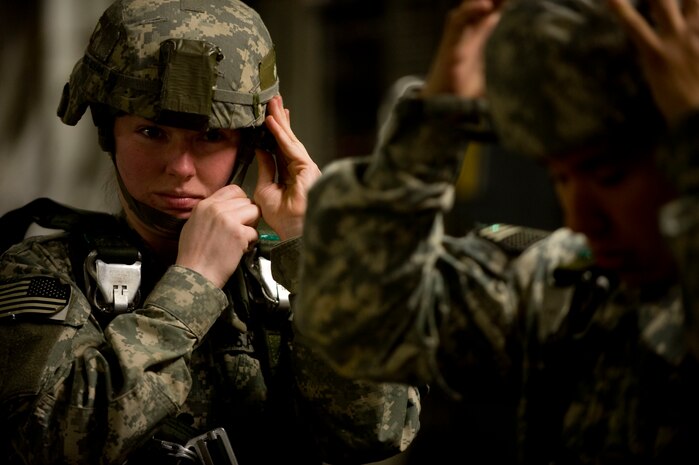 U.S. Army Spc. Katelyn Jovani of the 2-319th Airborne Field Artillery, 82nd Airborne Division, Ft. Bragg, N.C ., prepares for a jump during Operation Thunderstruck. Airmen and C-17 aircraft from Charleston Air Force Base, S.C., conducted a joint strategic brigade airdrop exercise with Soldiers over North Auxiliary Airfield near North, S.C., Dec. 16, 2009, demonstrating the global projection of U.S. airpower. Airborne Soldiers from the 2-319th Airborne Field Artillery, 82nd Airborne Division, Ft. Bragg, N.C., were airdropped in the exercise along with cargo pallets to simulate the seizure of a remote airfield, providing a joint training opportunity for the Airmen and Soldiers. The training mission included airdrops over North Auxiliary Airfield, aerial refueling training and simulated aeromedical evacuation. (U.S. Air Force photo/Tech. Sgt. Adrian Cadiz)(Released) 