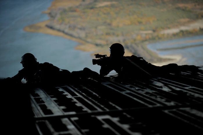 U.S. Air Force Staff Sgt. John Hoffman and U.S. Air Force Staff Sgt. Shawn Weismiller from the 1st Combat Camera Squadron, Charleston Air Force Base, S.C., documents Operation Thunderstruck, a strategic brigade airdrop exercise, Dec. 16, 2009.  Airmen and C-17 aircraft from Charleston AFB conducted the large formation exercise, demonstrating the global projection of U.S. airpower.  The training mission utilized Airborne Soldiers from the 2-319th Airborne Field Artillery, 82nd Airborne Division, Ft. Bragg, N.C. and 12 C-17 aircraft that performed airdrops over North Auxiliary Airfield, aerial refueling training, and simulated aero medical evacuation. (U.S. Air Force photo/Tech. Sgt. Dennis J. Henry Jr.)(Released)