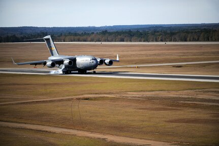 A C-17 aircraft from Charleston Air Force Base, S.C. lands at North Auxiliary Airfield near North, S.C., during Operation Thunderstruck, a strategic brigade airdrop exercise, Dec. 16, 2009. Airborne Soldiers from the 82nd Airborne Division, Ft. Bragg, N.C., were airdropped during the exercise over the airfield along with cargo pallets to simulate the seizure of a remote airfield, providing a joint training opportunity for the Airmen and Soldiers. The training mission included airdrops over North Auxiliary Airfield, aerial refueling training and simulated aeromedical evacuation. (U.S. Air Force photo/Tech. Sgt. William Greer)(Released)
